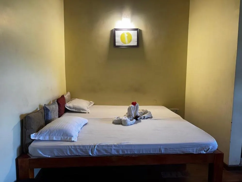 Bed in Satya Anand Cottage Pure Veg and Non Alcoholic Hotel
