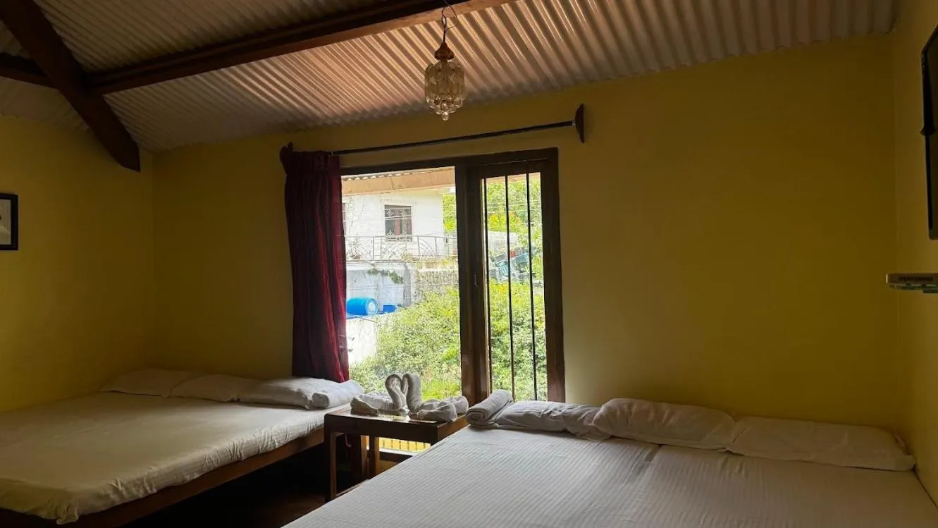 Bed in Satya Anand Cottage Pure Veg and Non Alcoholic Hotel