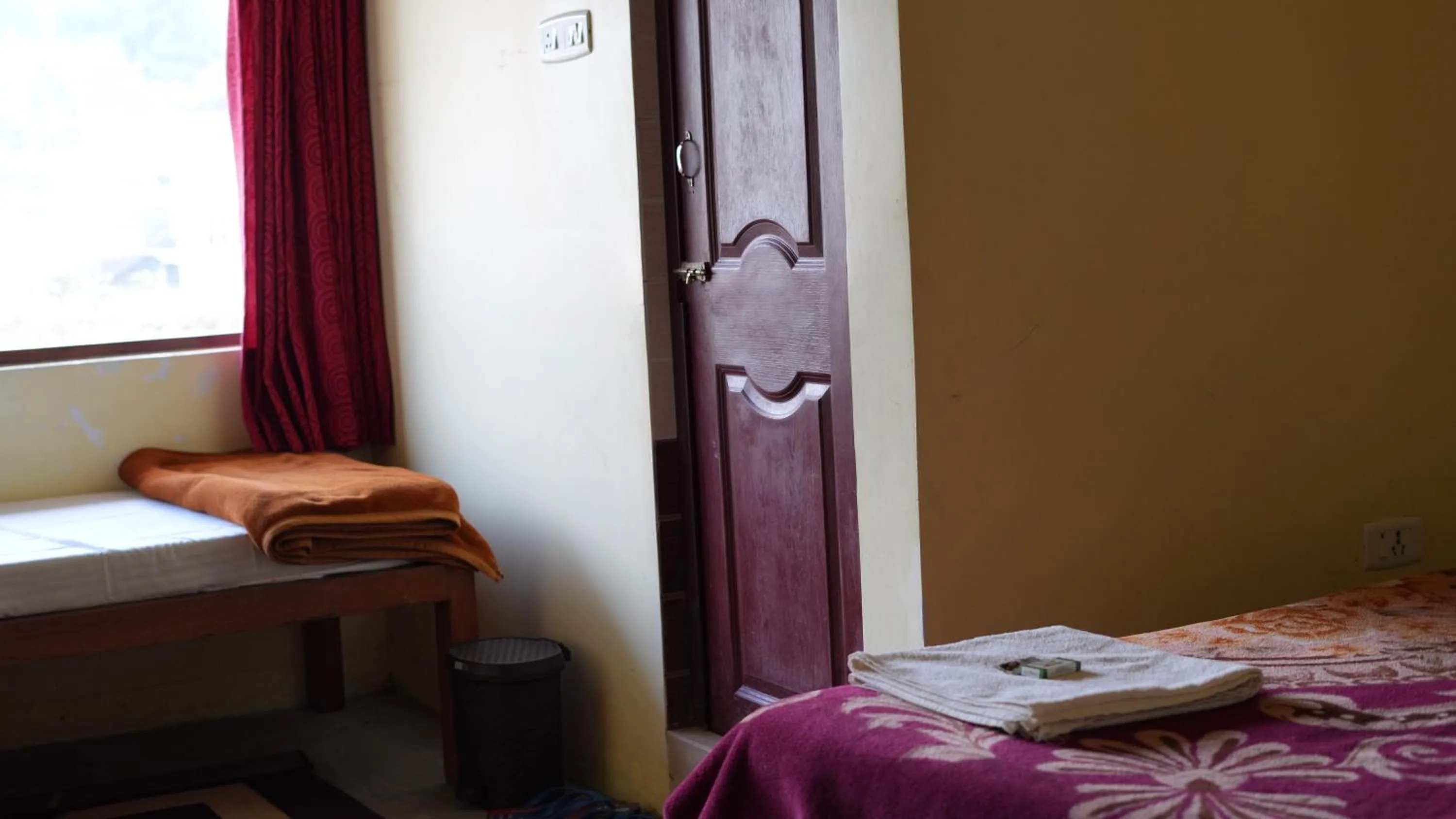 Bed in Satya Anand Cottage Pure Veg and Non Alcoholic Hotel