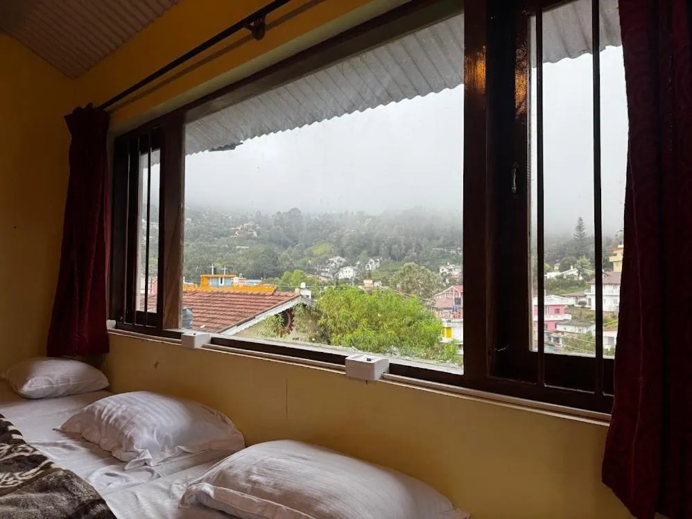 Bed in Satya Anand Cottage Pure Veg and Non Alcoholic Hotel