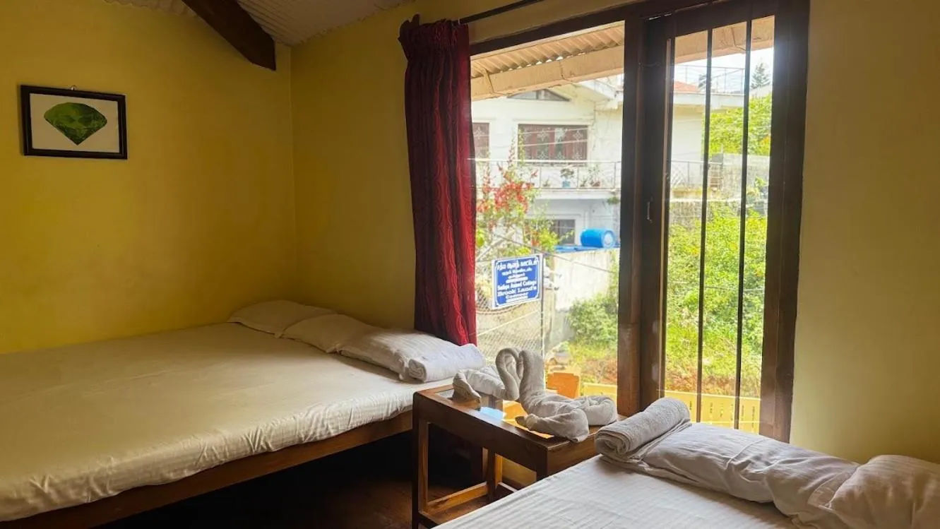 Bed in Satya Anand Cottage Pure Veg and Non Alcoholic Hotel