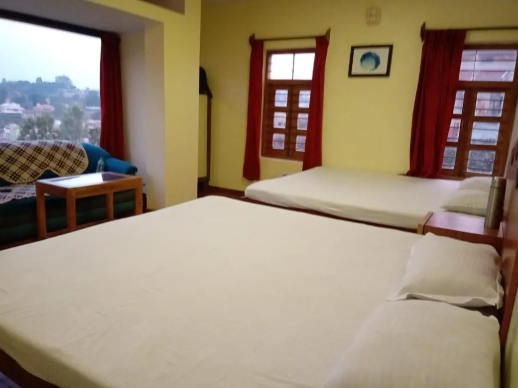 Bed in Satya Anand Cottage Pure Veg and Non Alcoholic Hotel