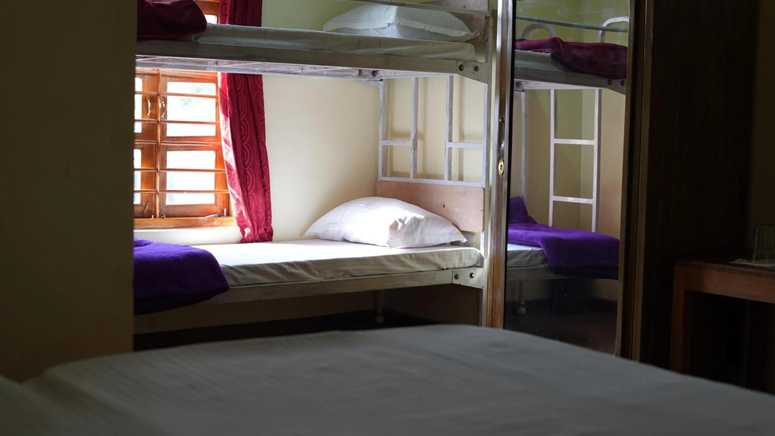 Bed in Satya Anand Cottage Pure Veg and Non Alcoholic Hotel