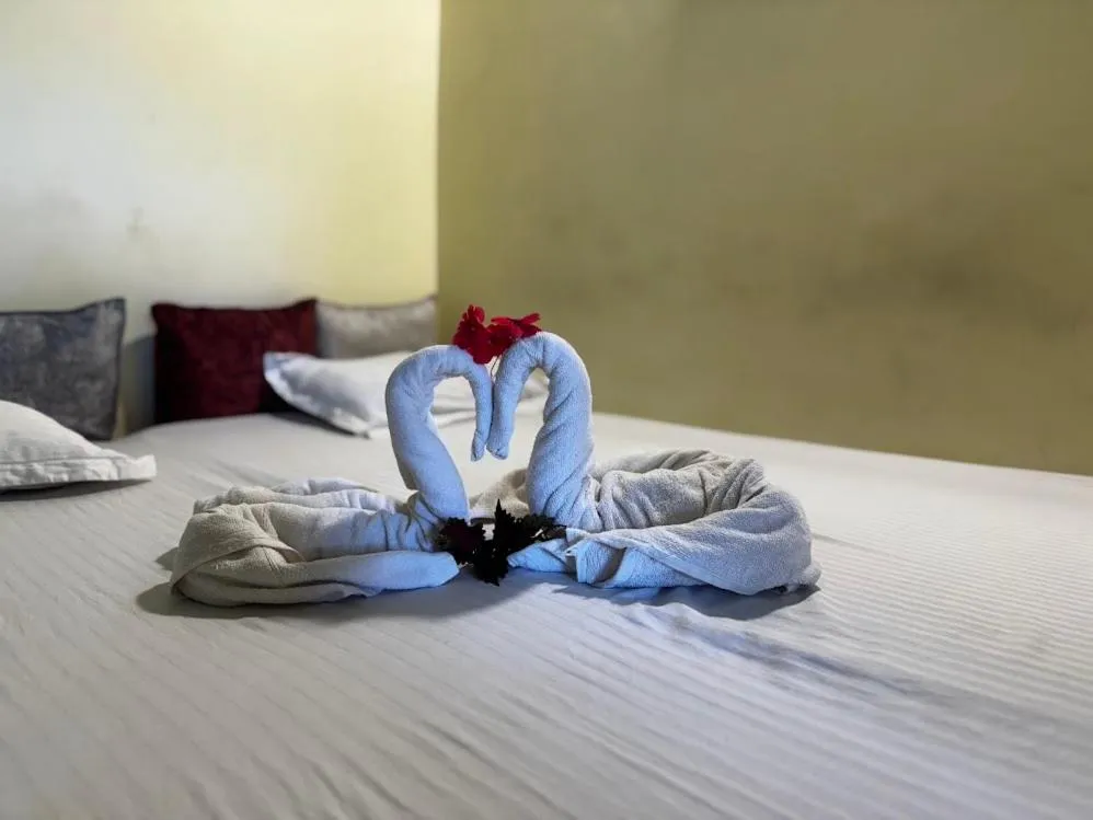 Bed in Satya Anand Cottage Pure Veg and Non Alcoholic Hotel