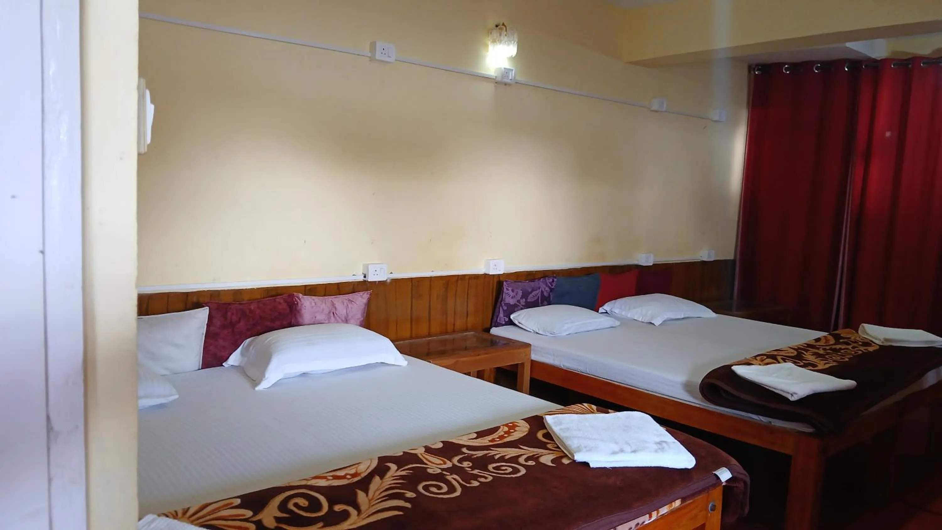Bed in Satya Anand Cottage Pure Veg and Non Alcoholic Hotel