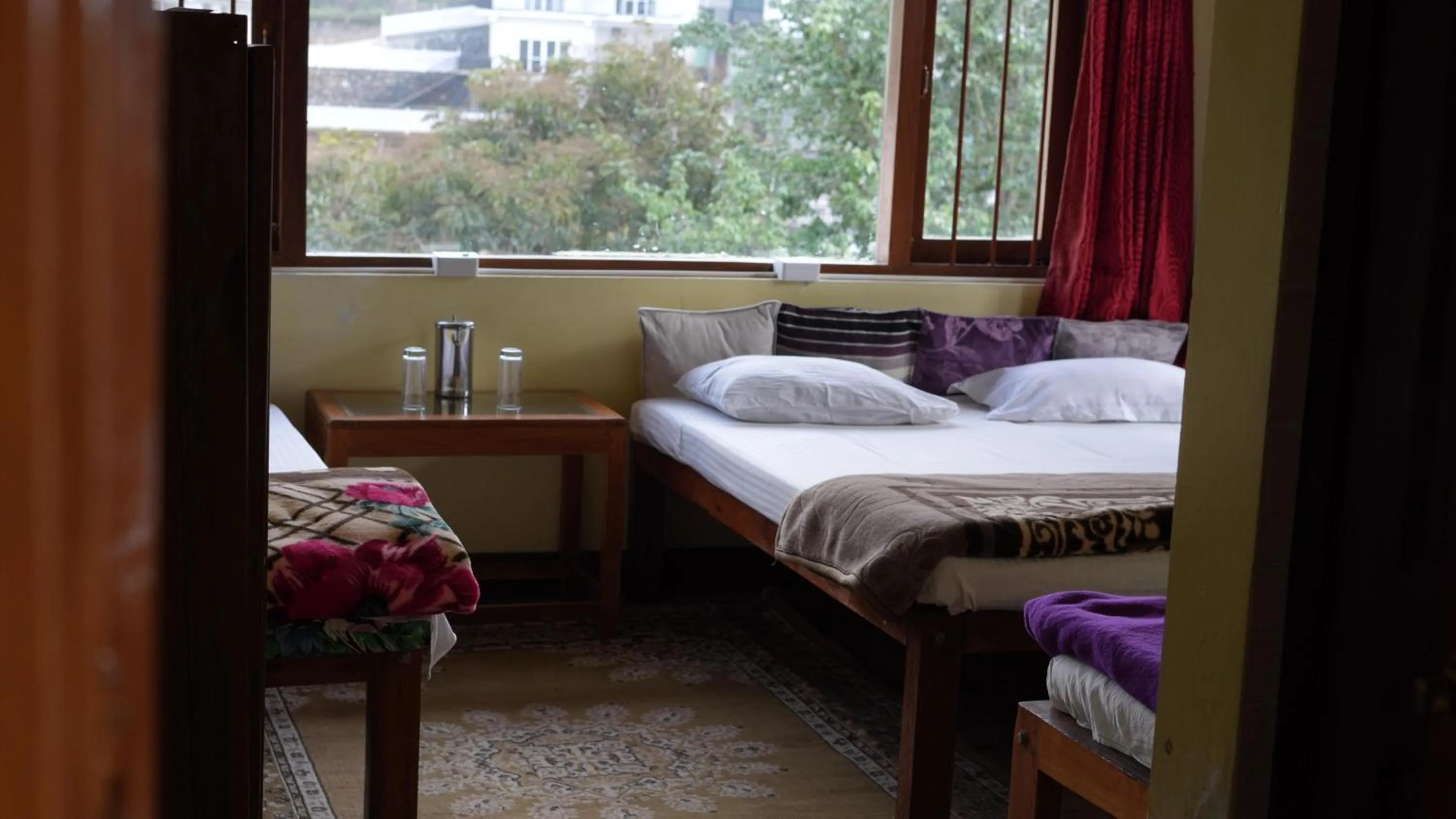 Bed in Satya Anand Cottage Pure Veg and Non Alcoholic Hotel