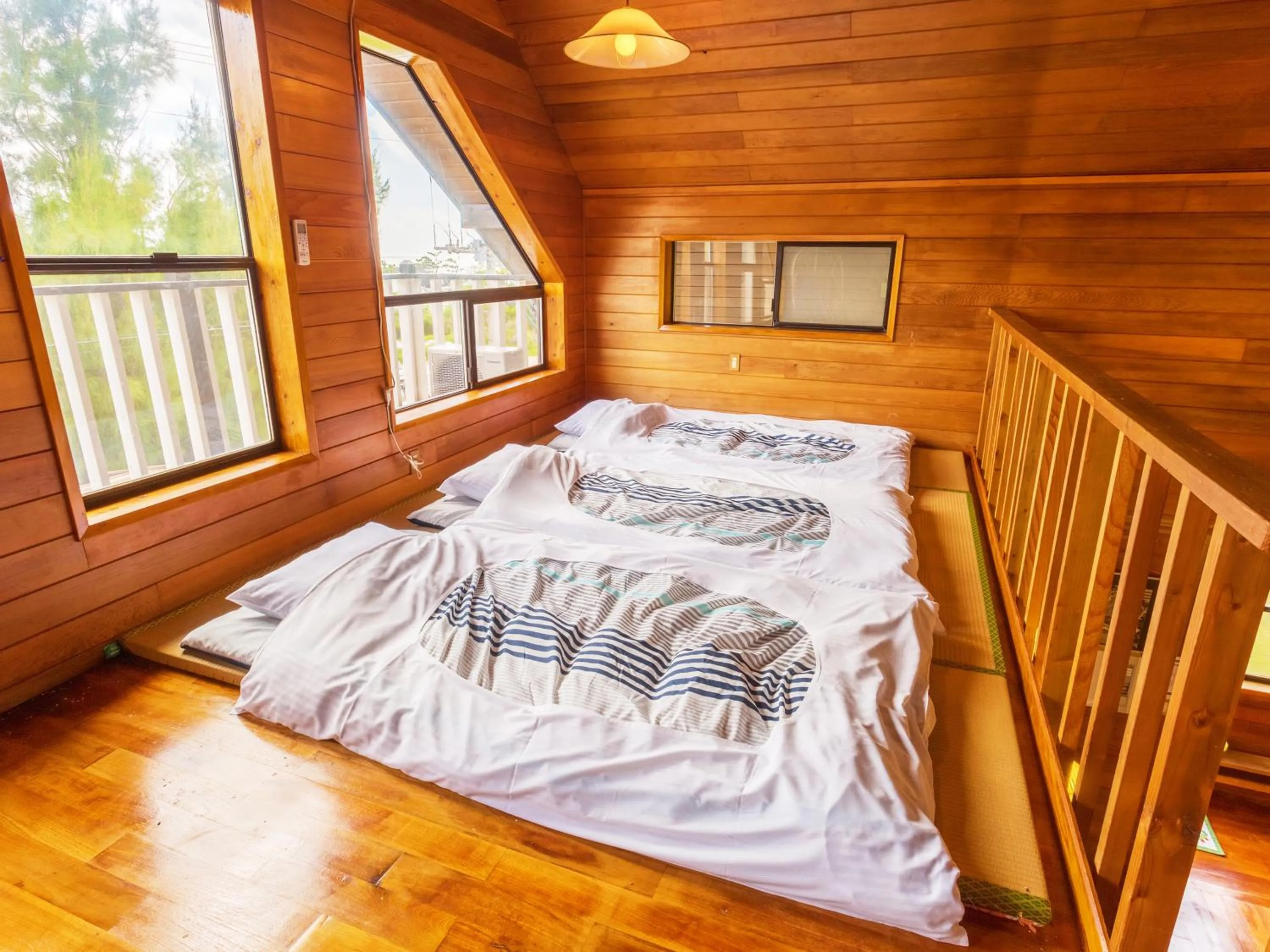 Living room, Bed in Kariyushi Condominium Resort Yuudekiya