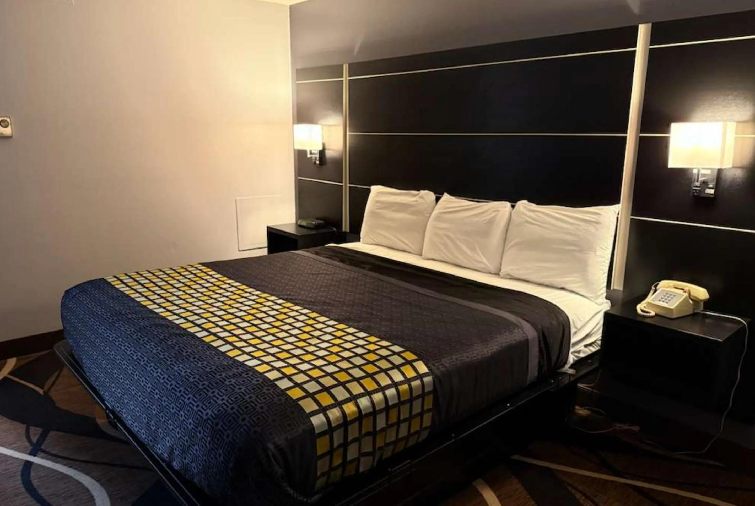 Bed in Coratel Inn & Suites by Jasper Hastings