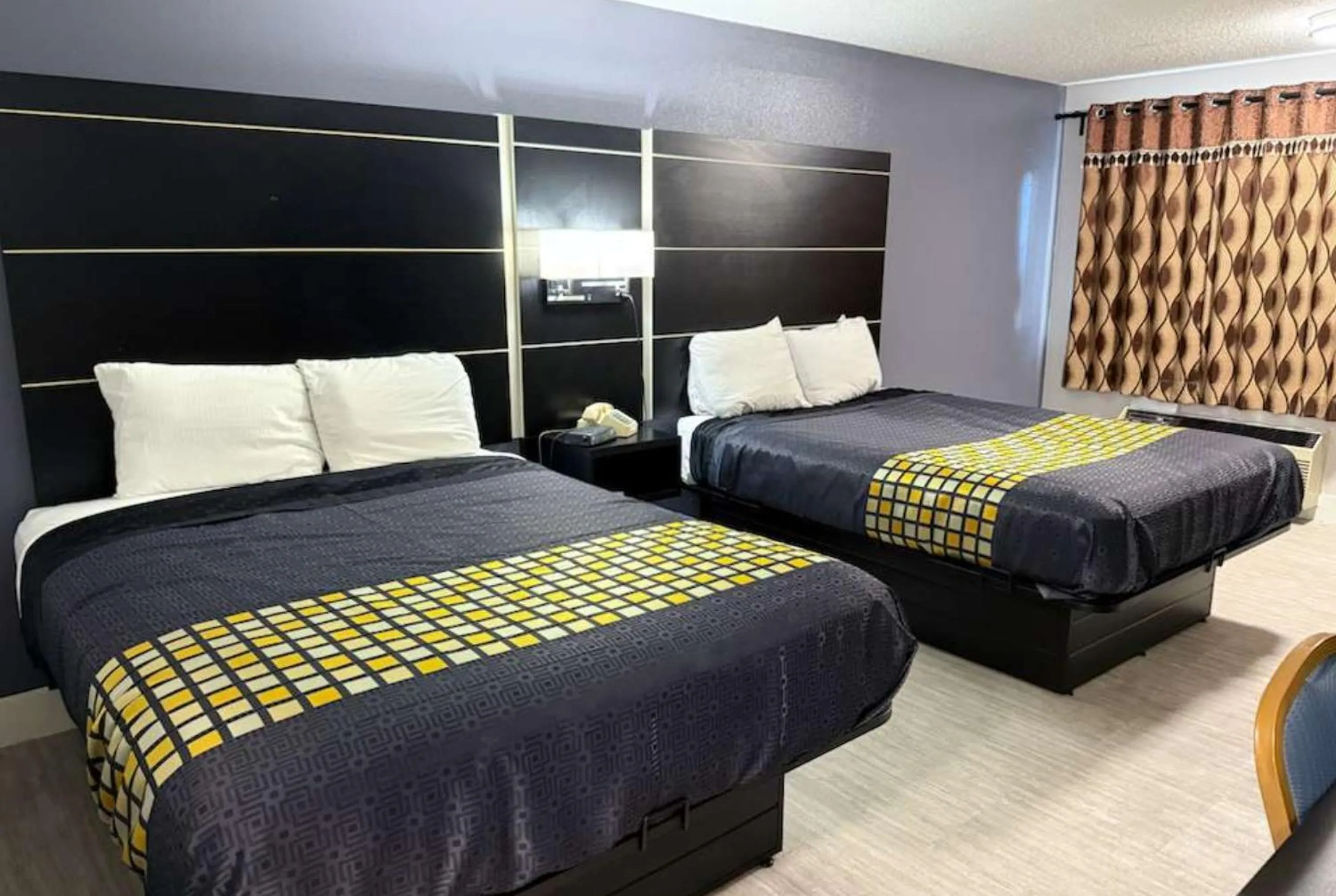 Bed in Coratel Inn & Suites by Jasper Hastings