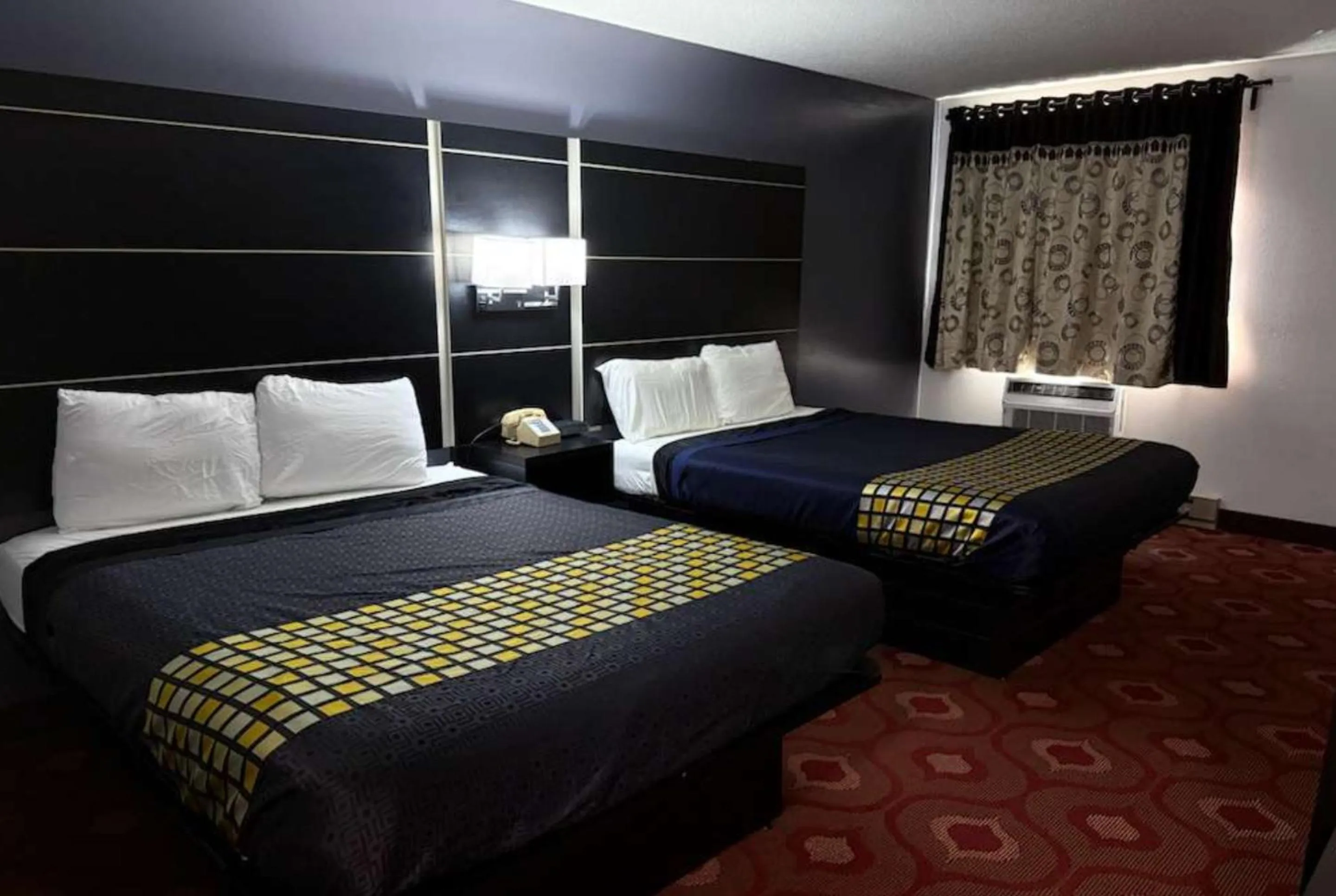 Bed in Coratel Inn & Suites by Jasper Hastings