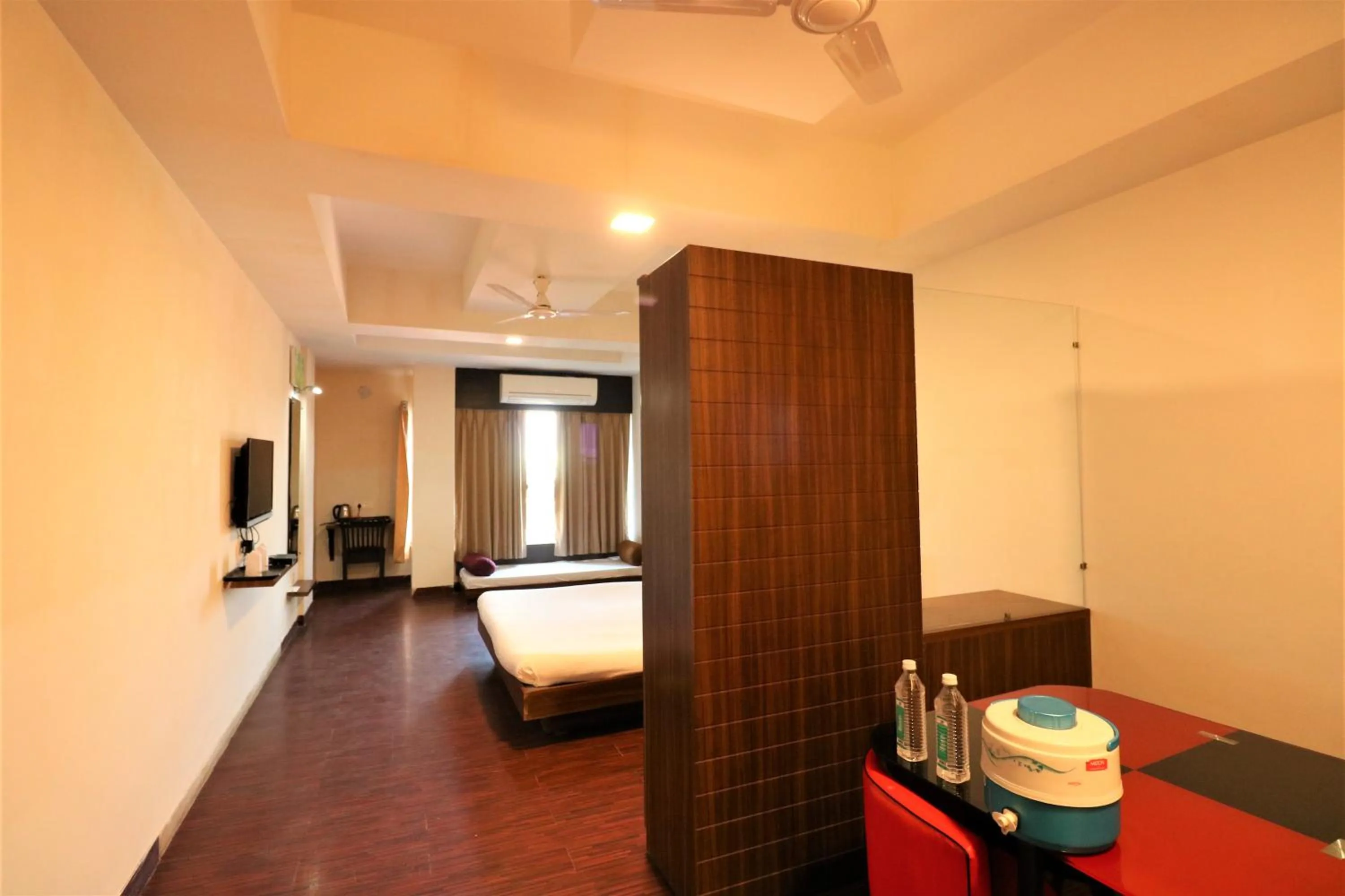 Dining area, Bed in Goverdhan Greens Resort Dwarka l Hotels In Dwarka