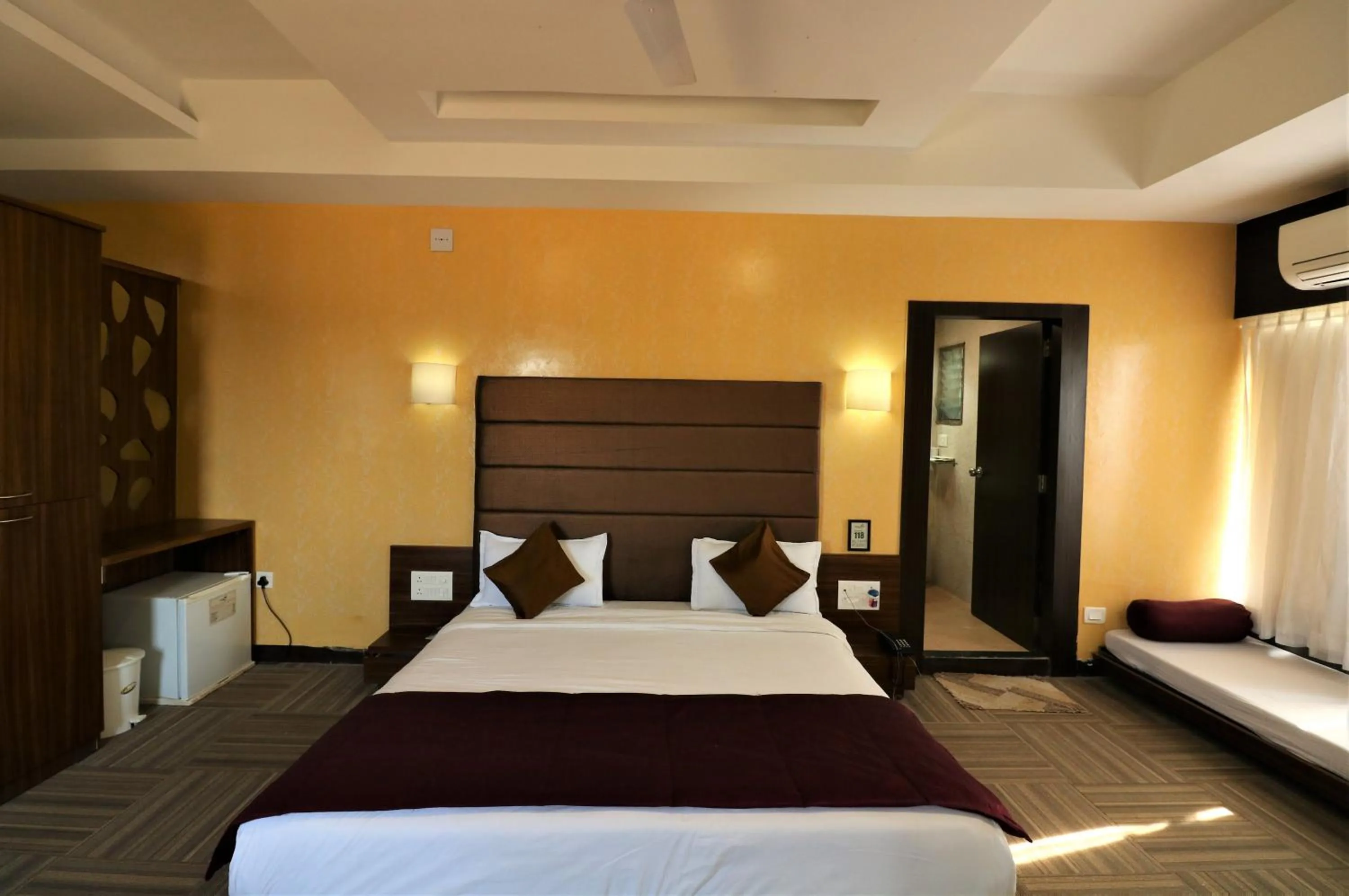 Photo of the whole room, Bed in Goverdhan Greens Resort Dwarka l Hotels In Dwarka