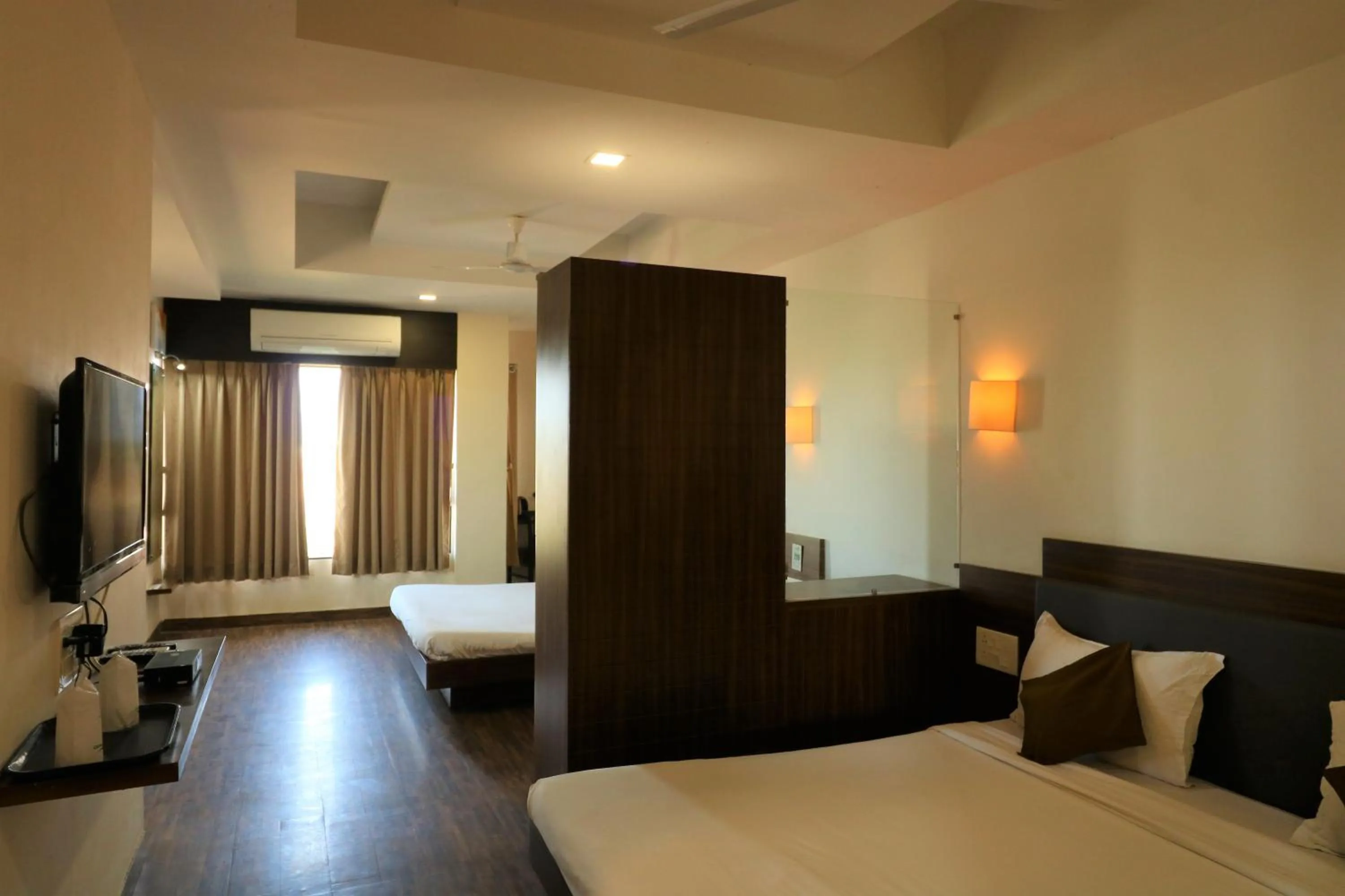 Photo of the whole room, Bed in Goverdhan Greens Resort Dwarka l Hotels In Dwarka