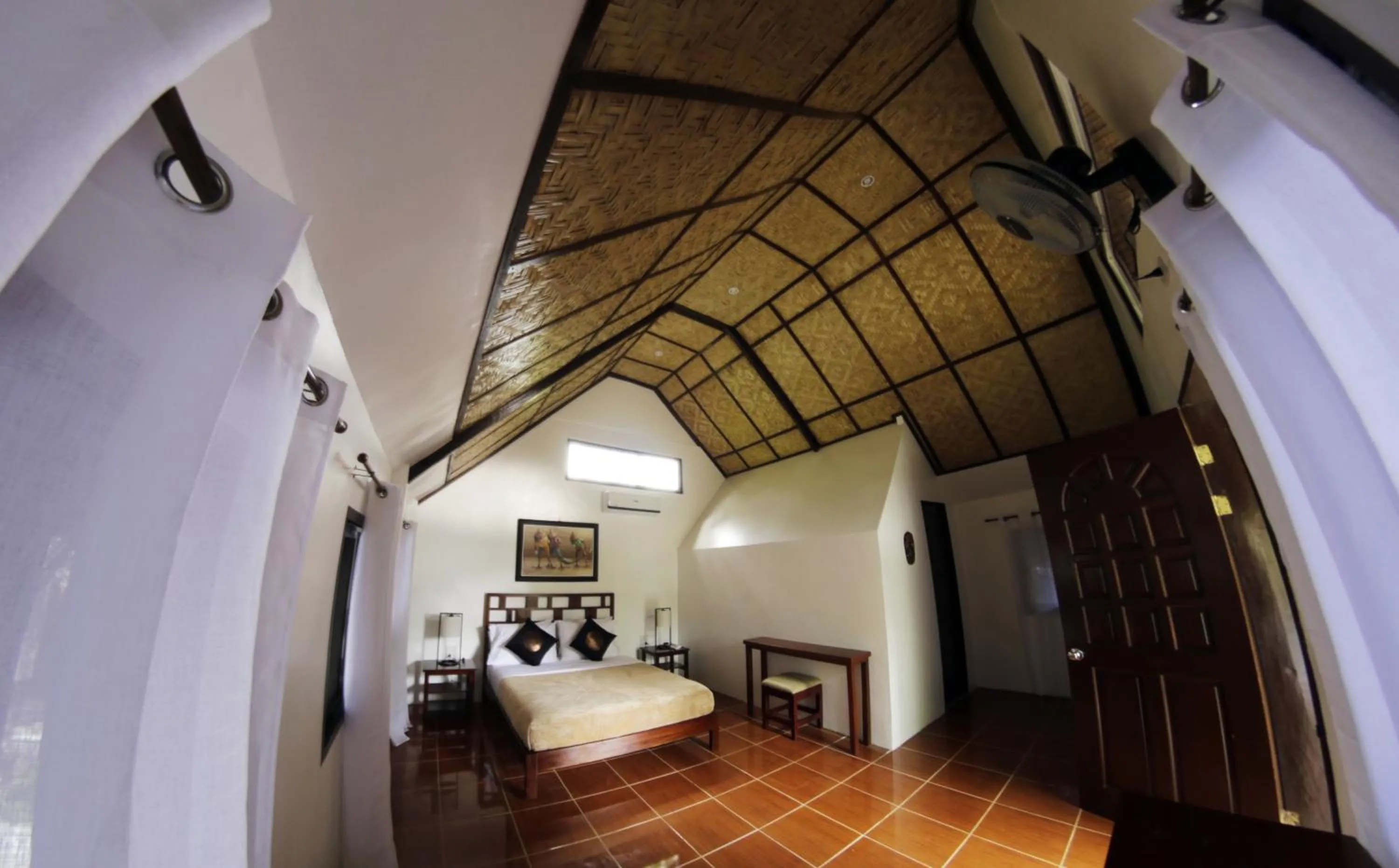 Bed in Cabilao Sanctuary Beach & Dive Resort