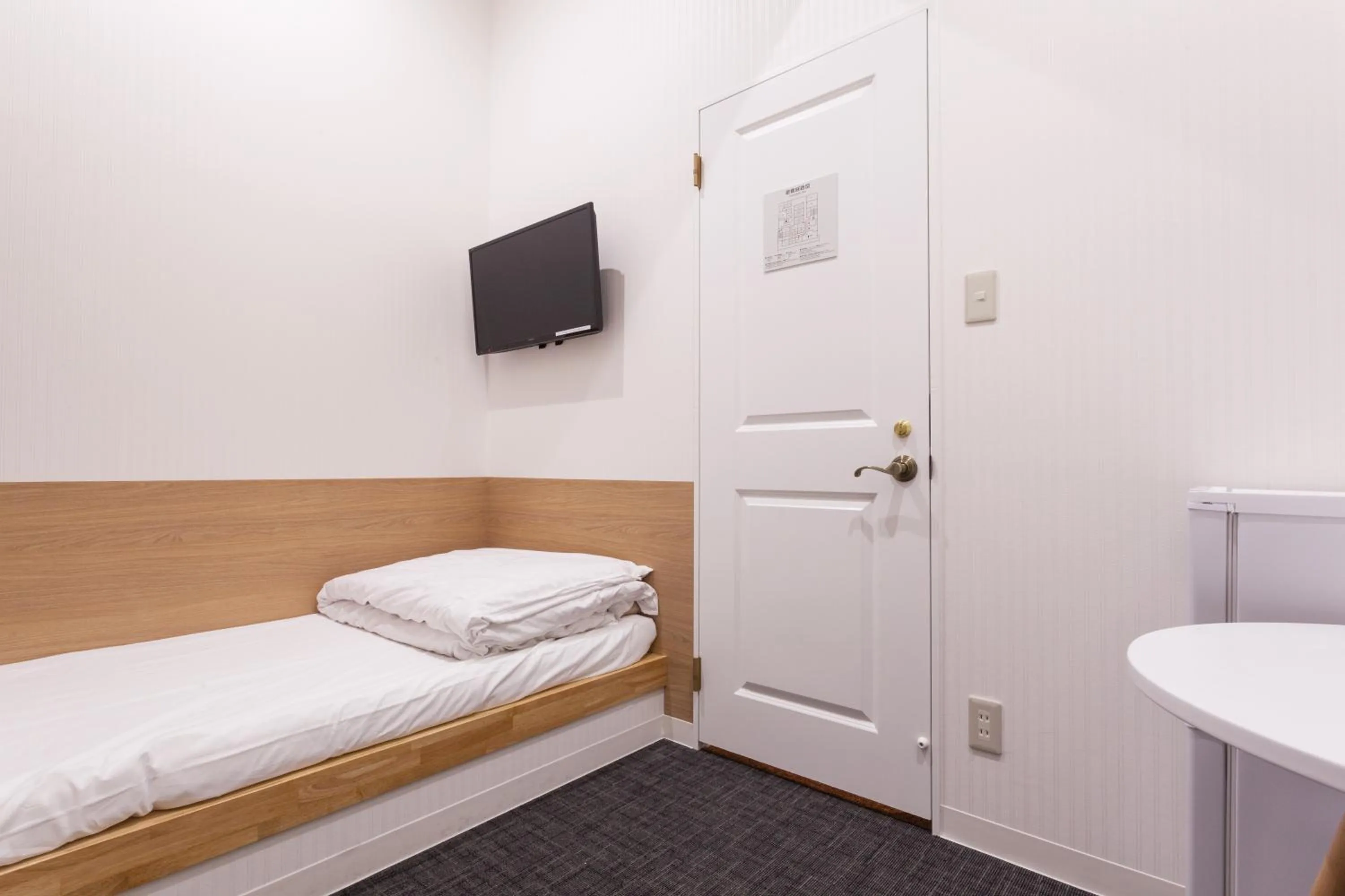 Photo of the whole room, Bed in HOTEL THE CUBE Naha Kokusai Street