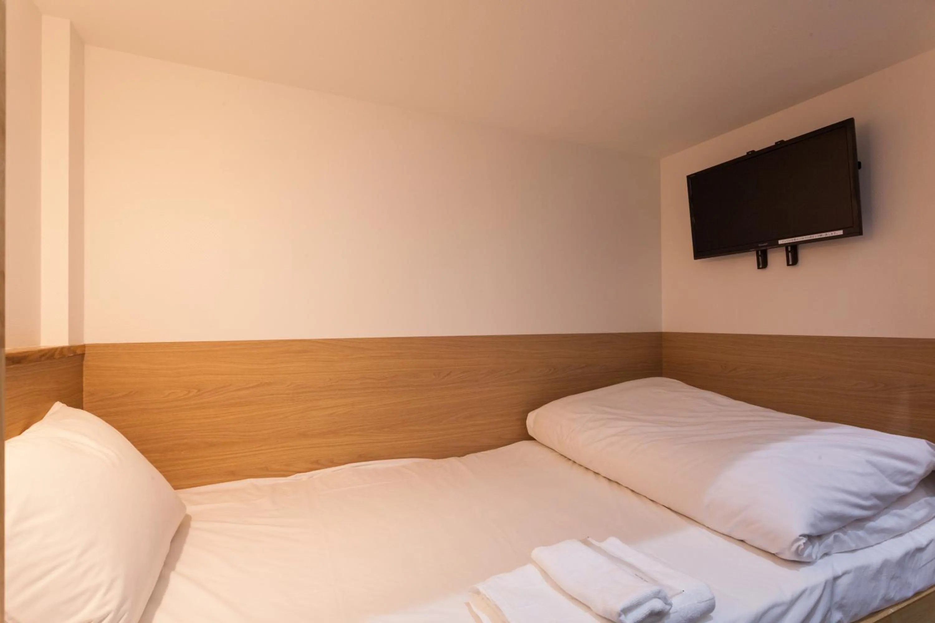 Photo of the whole room, Bed in HOTEL THE CUBE Naha Kokusai Street