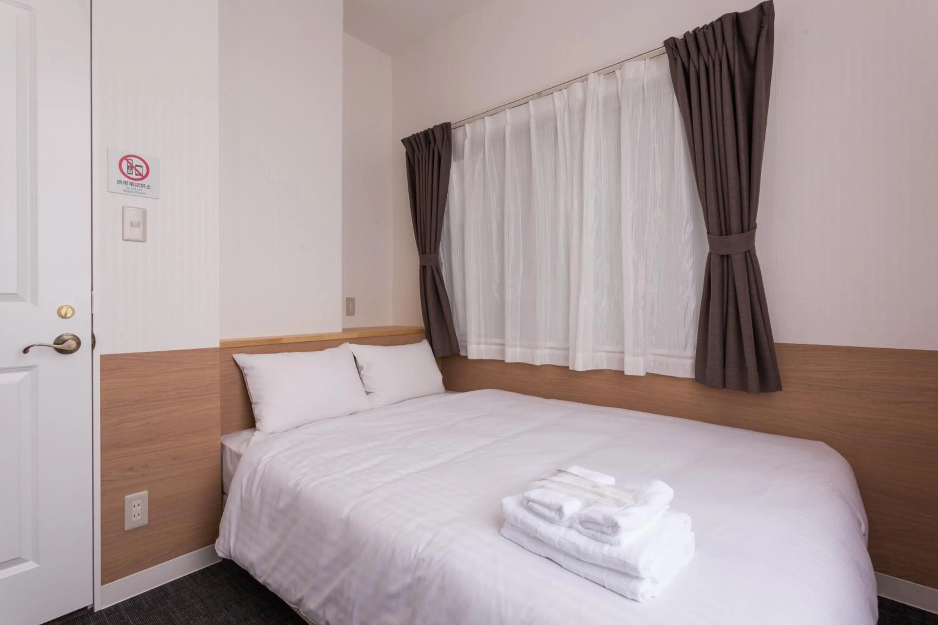 Photo of the whole room, Bed in HOTEL THE CUBE Naha Kokusai Street