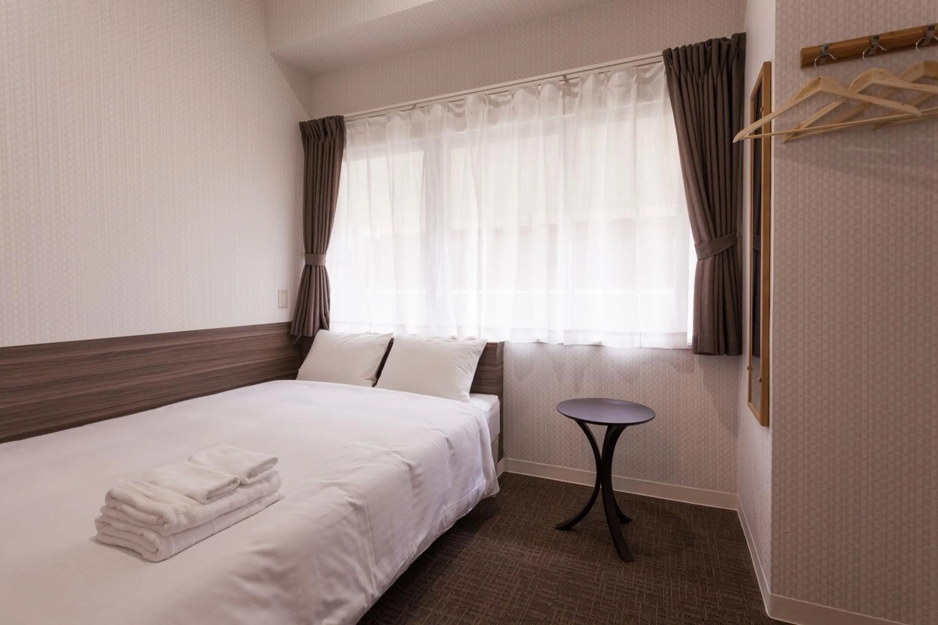 Photo of the whole room, Bed in HOTEL THE CUBE Naha Kokusai Street