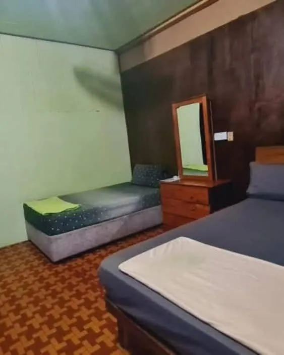 Bed in Rainbow Tioman Cottage