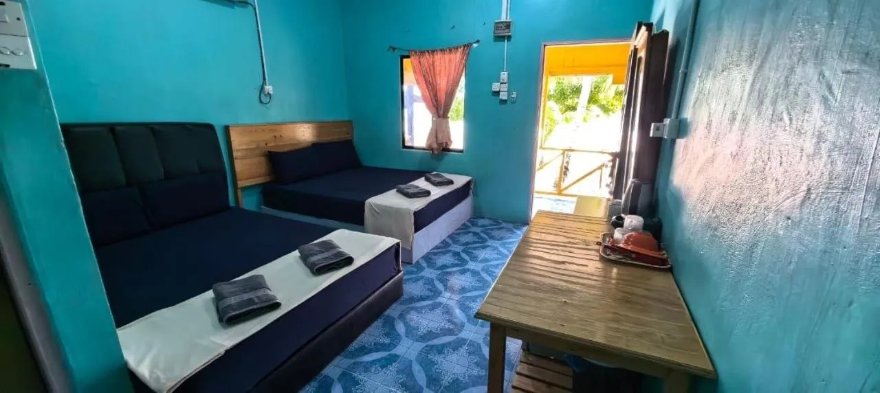 Bed in Rainbow Tioman Cottage