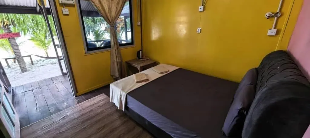 Bed in Rainbow Tioman Cottage