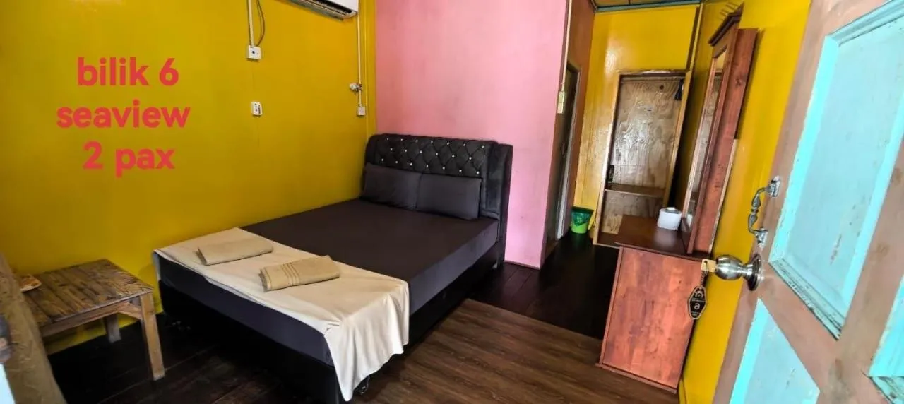 Bed in Rainbow Tioman Cottage