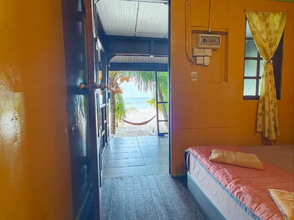 Bed in Rainbow Tioman Cottage