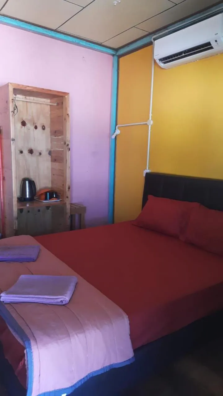 Bed in Rainbow Tioman Cottage
