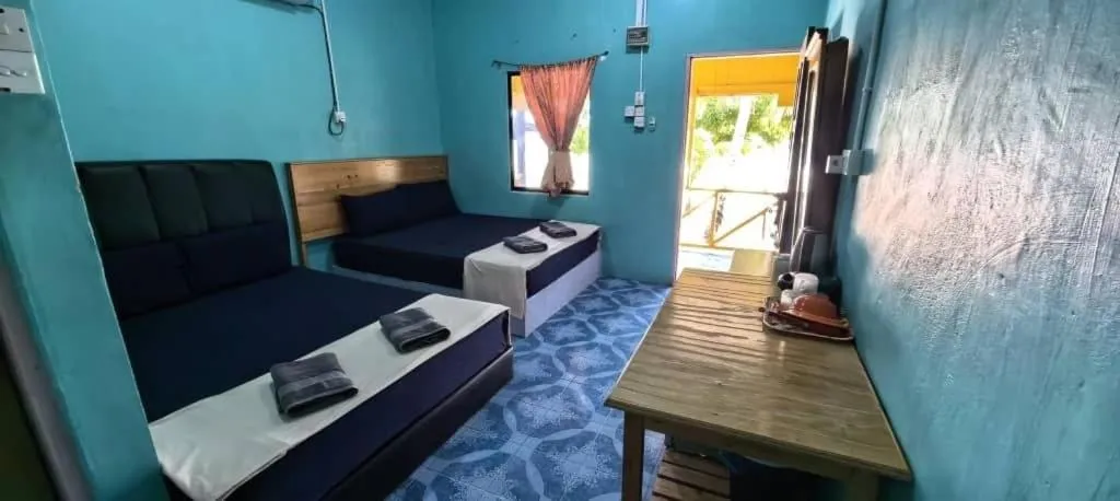 Bed in Rainbow Tioman Cottage