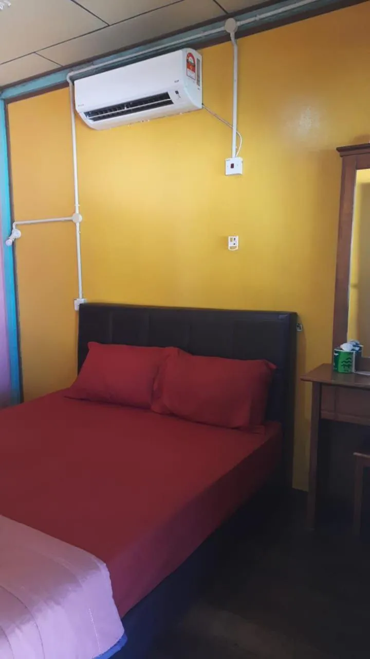 Bed in Rainbow Tioman Cottage