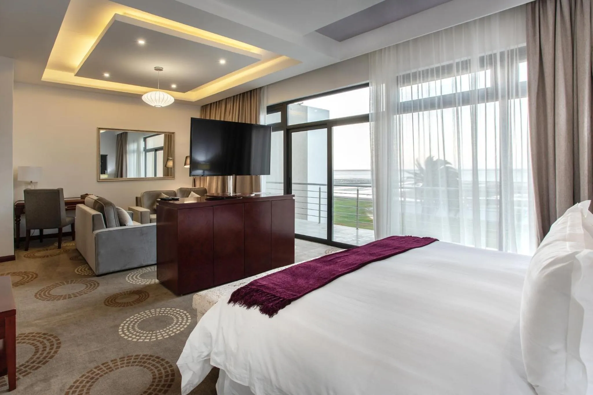 Communal lounge/ TV room, Bed in Flamingo Villas Boutique Hotel