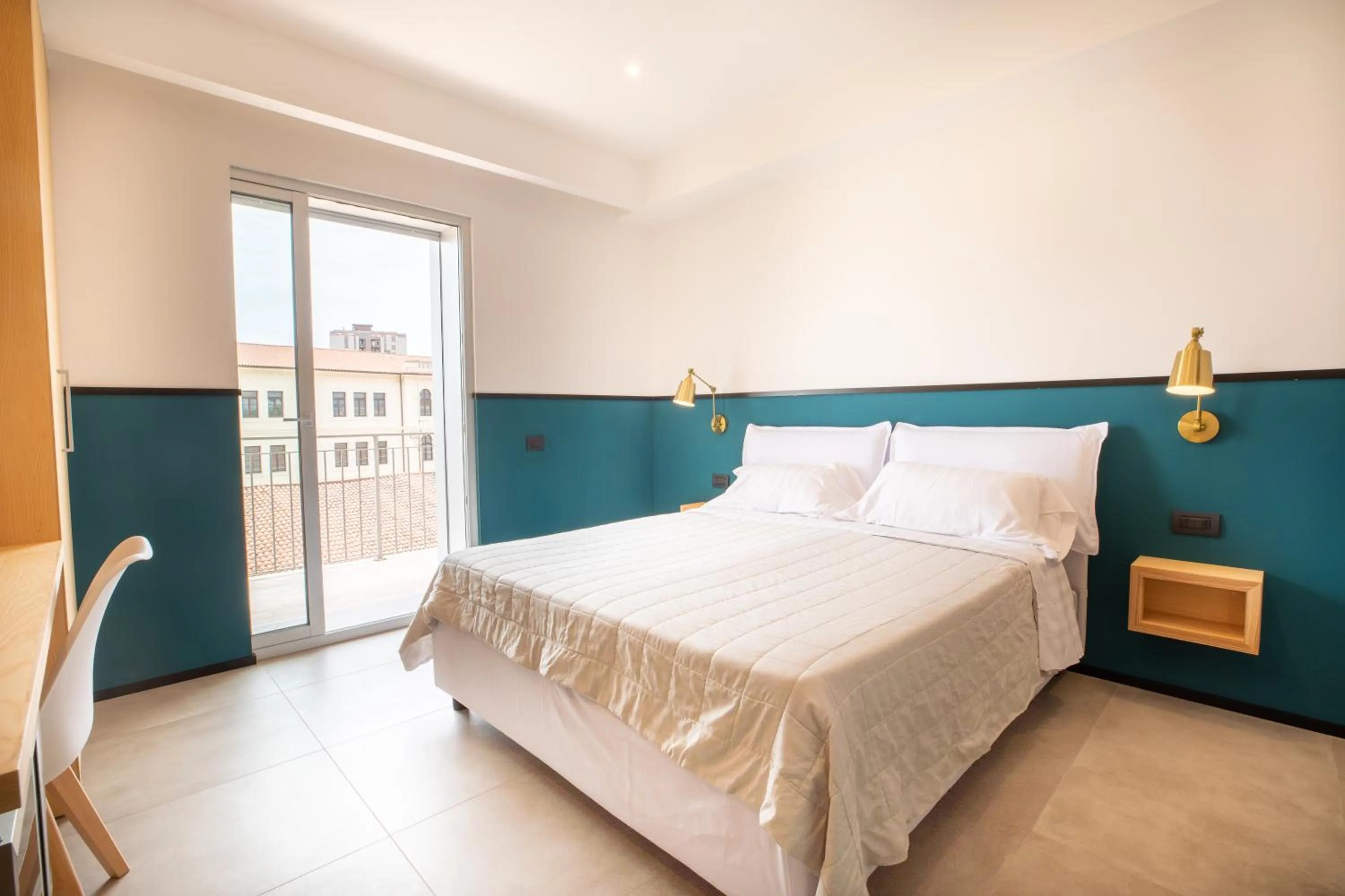 Bed in Antares Rooms and Suites