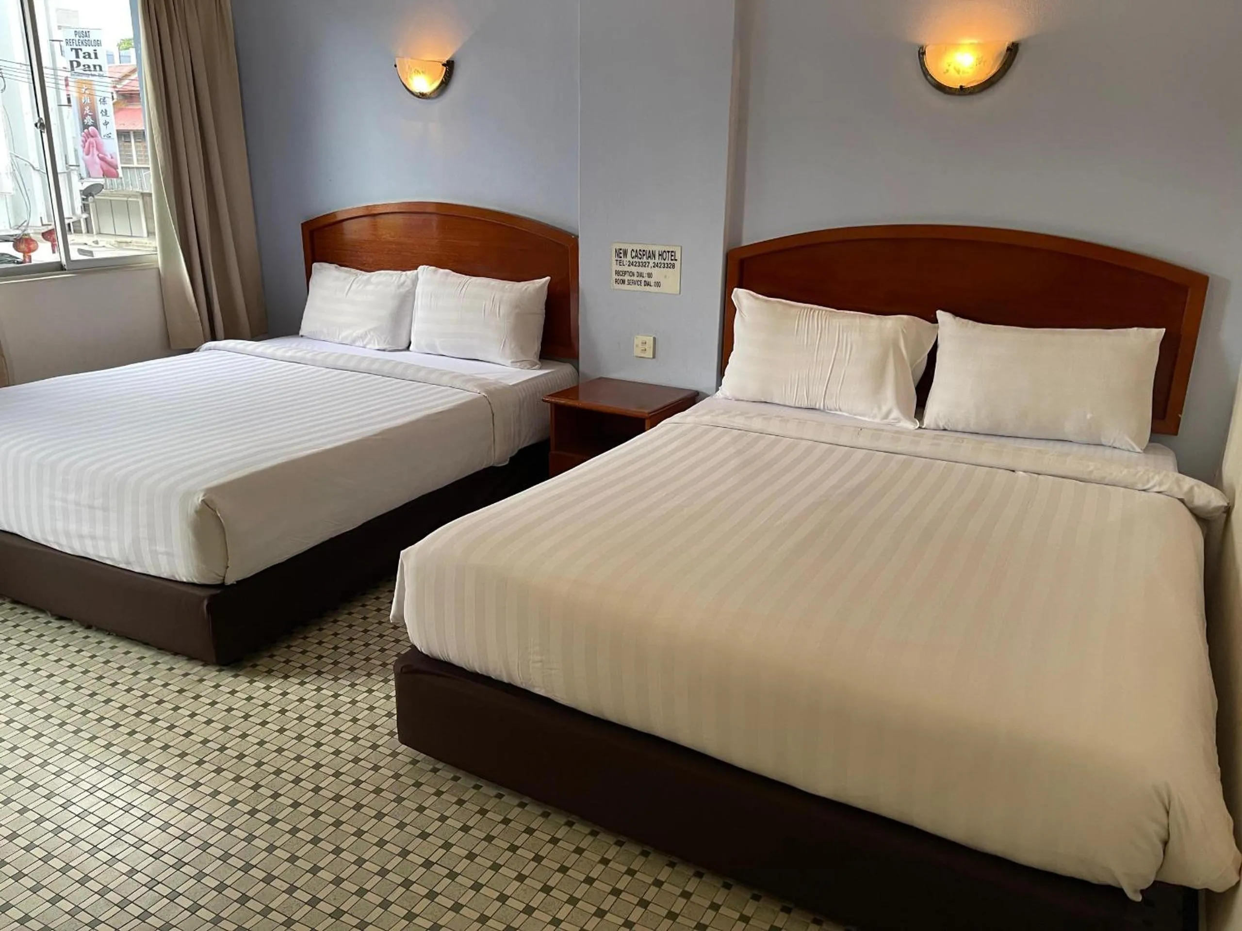 Bed in New Caspian Hotel