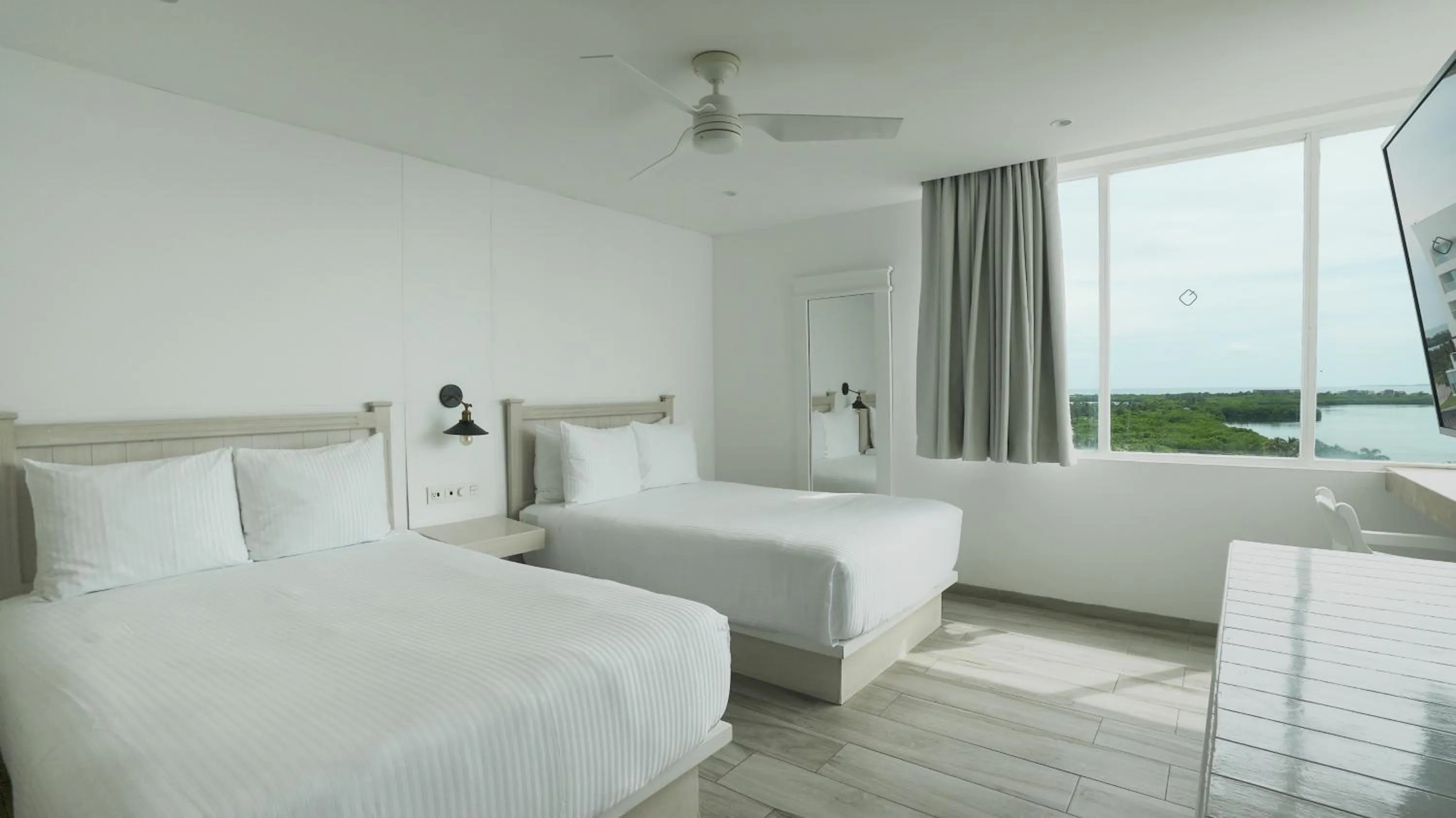 Bed in Oleo Cancun Playa All Inclusive Resort