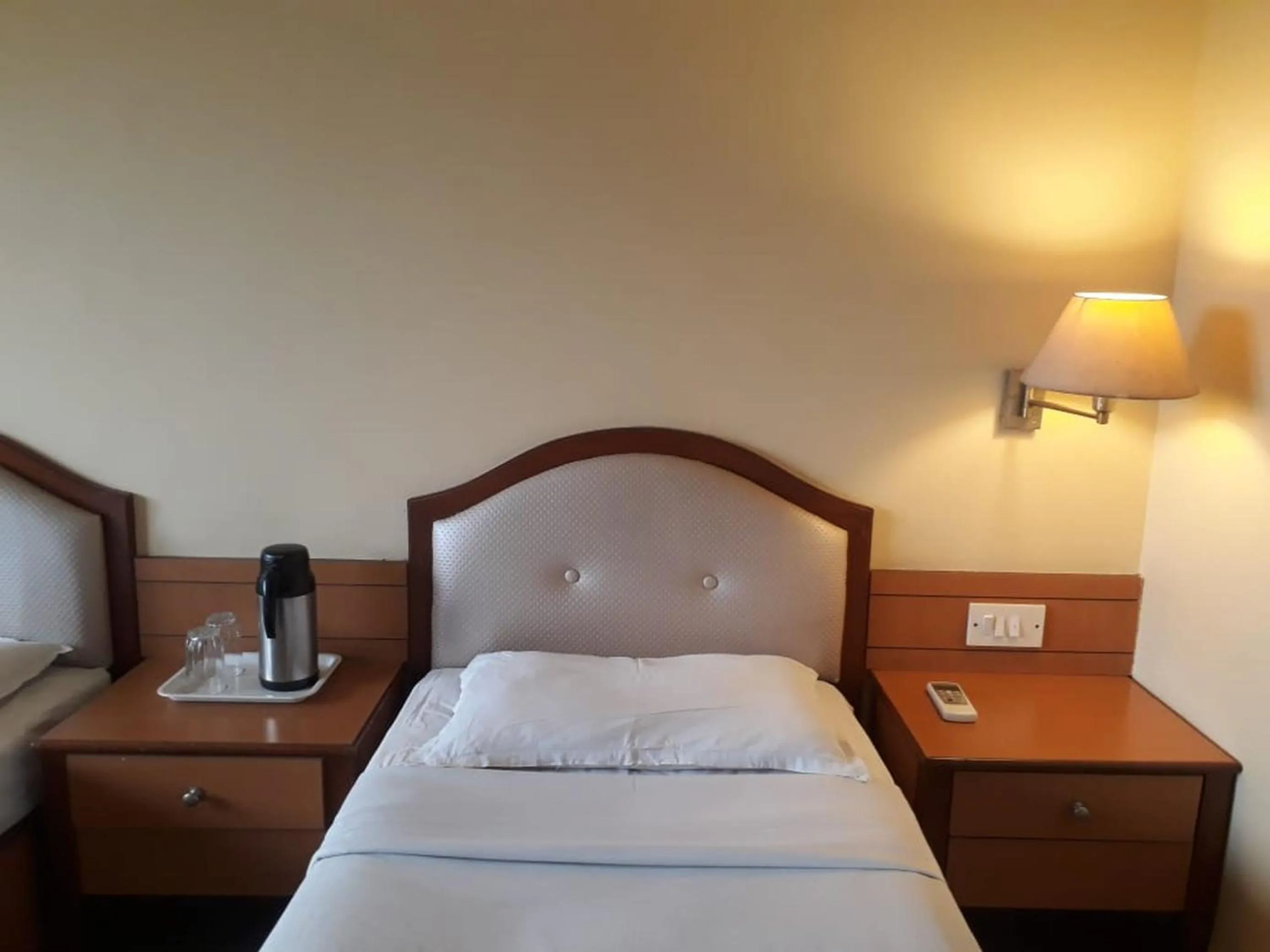 Bed in The Samrat Hotel near Pune Railway Station