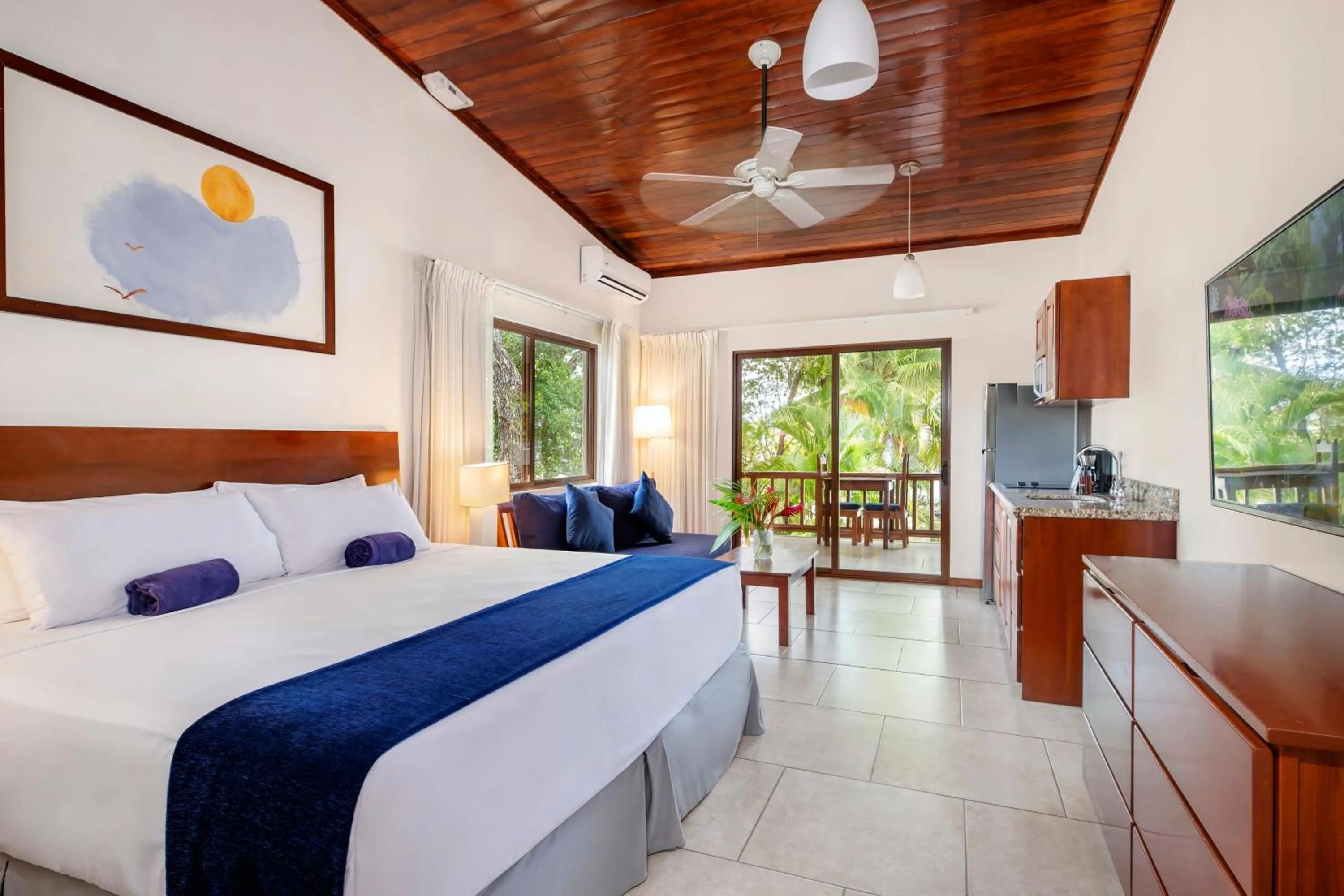 Kitchen or kitchenette, Bed in The Coast Beachfront Hotel