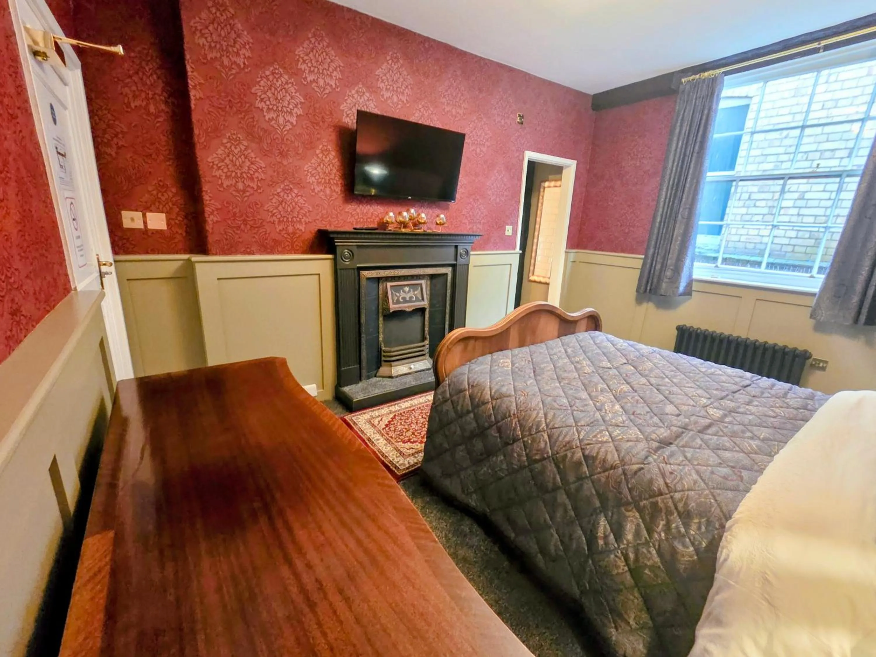 Bed in The New Inn by Roomsbooked