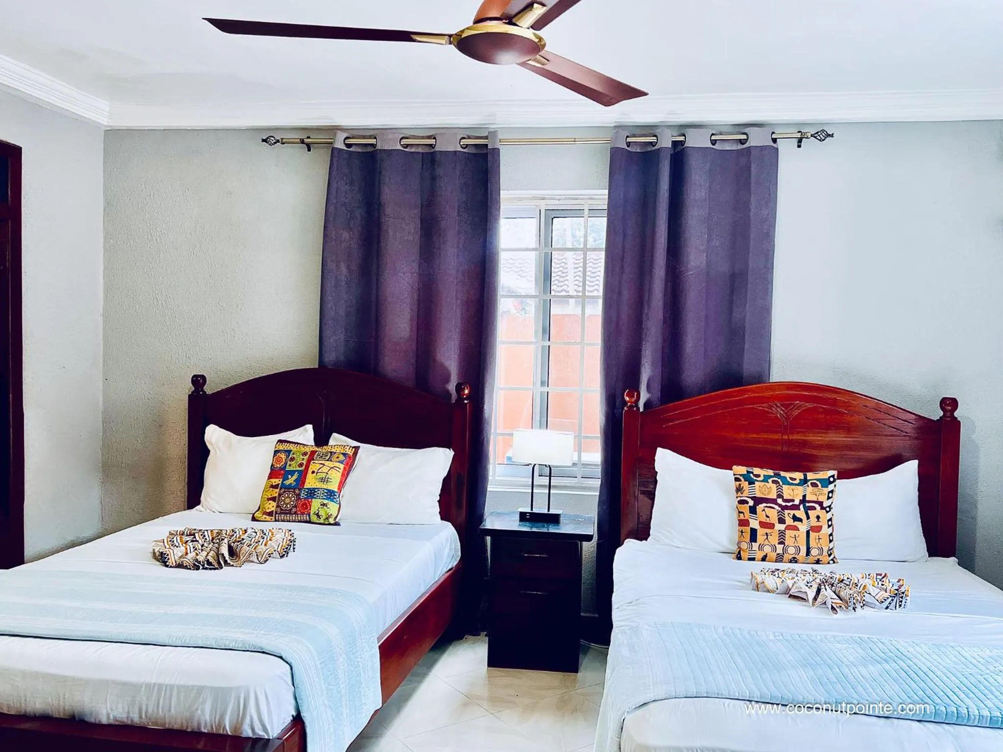 Bed in Coconut Pointe Villa & Beach Resort