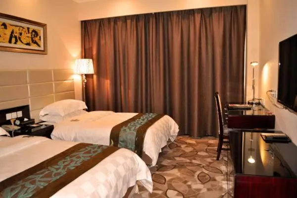 Bed, TV/Entertainment Center in Ramada Linyi North