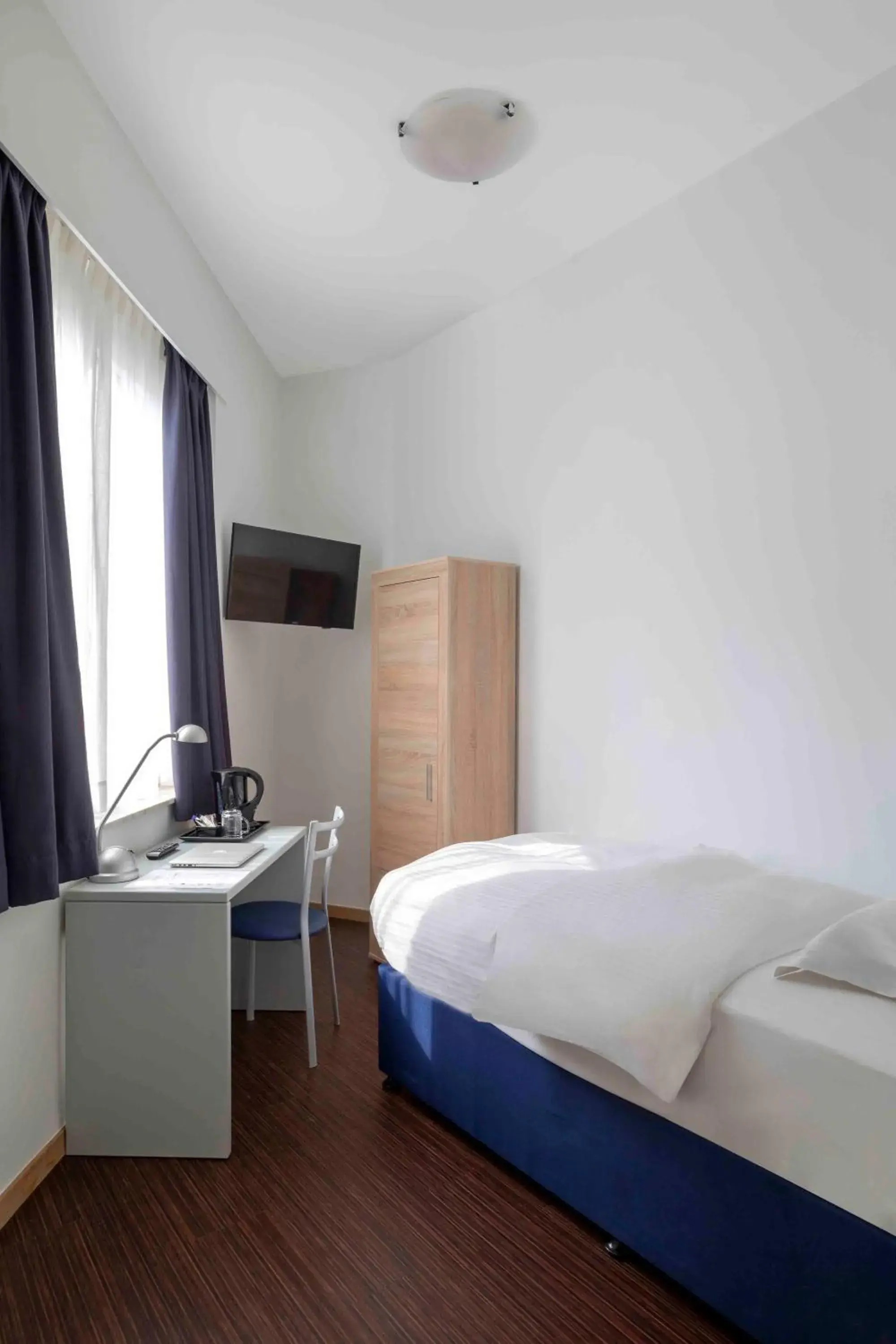 Bed in Hôtel Argus by happyCulture Bed in Hôtel Argus by happyCulture