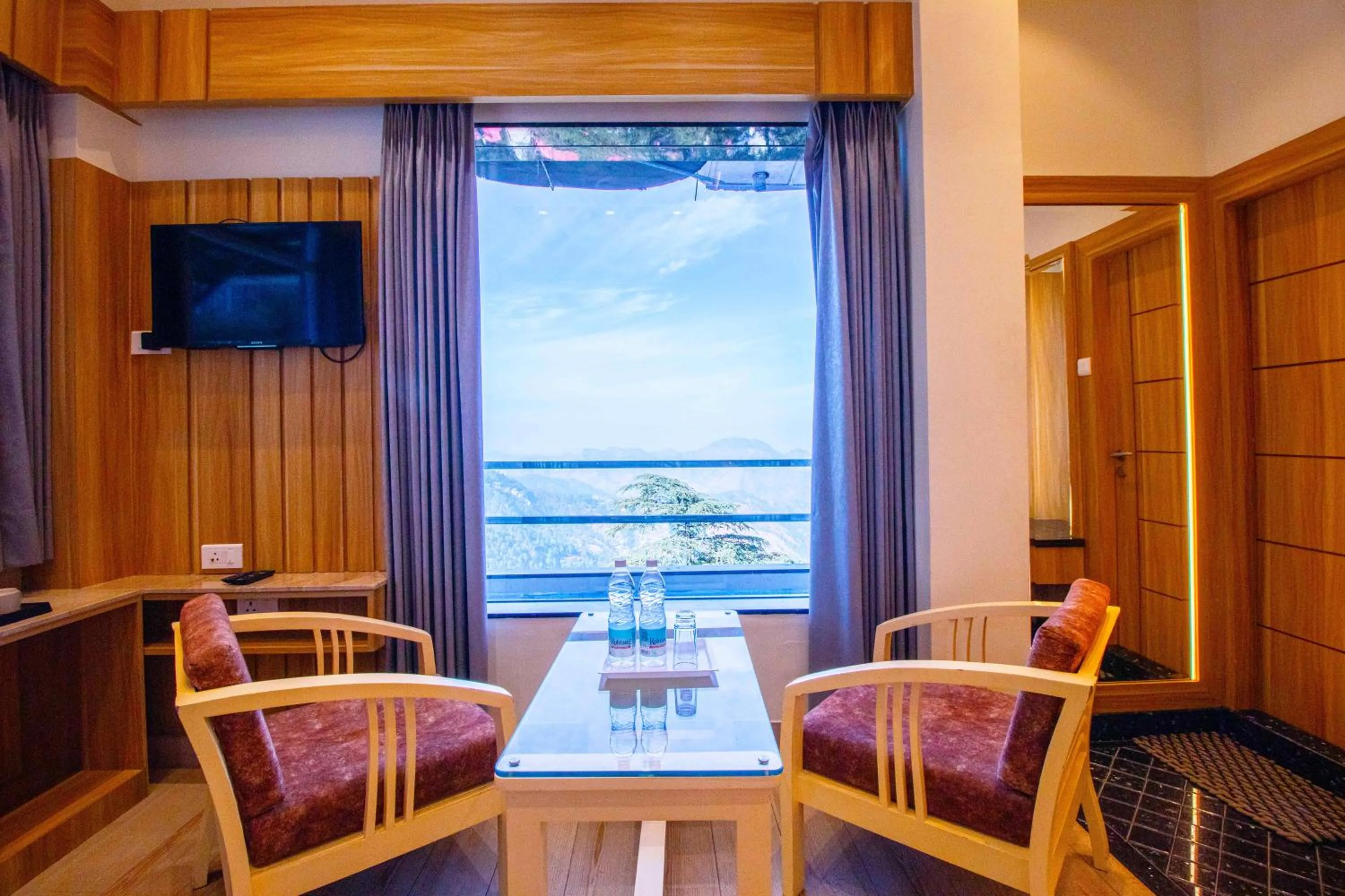 Bedroom in Treebo Varuna With Mountain View