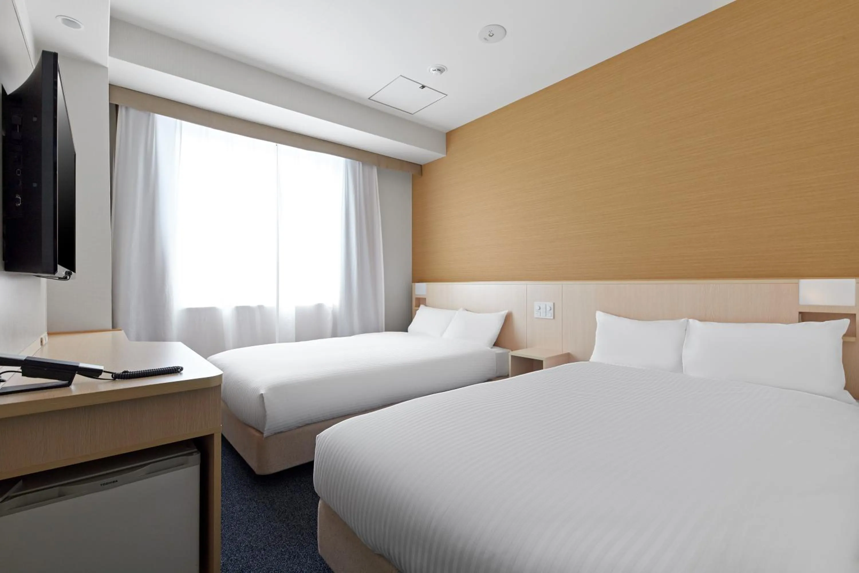 Bed in Sotetsu Fresa Inn Kyoto-Shijokarasuma