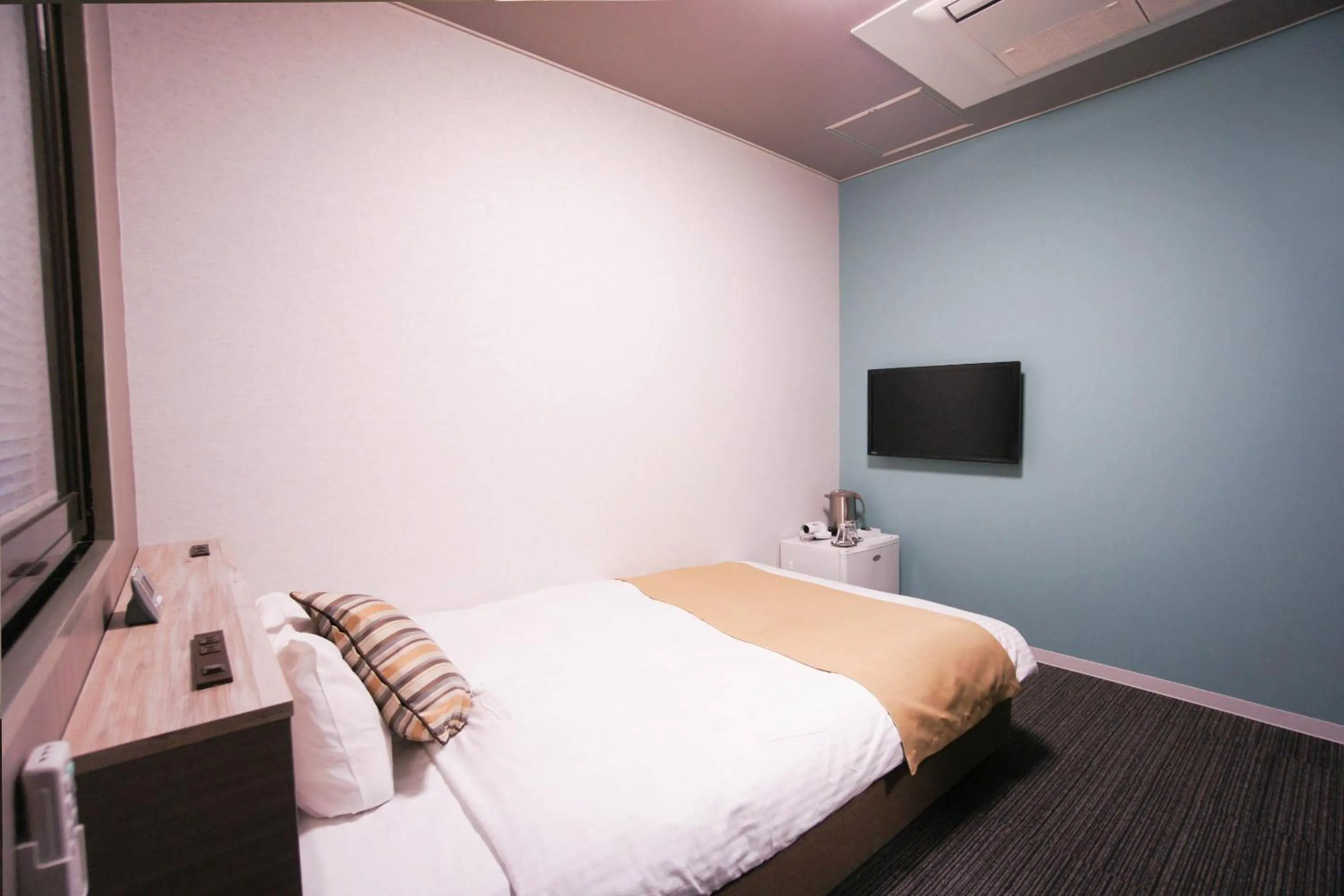 Bed in Hotel AreaOne Nobeoka