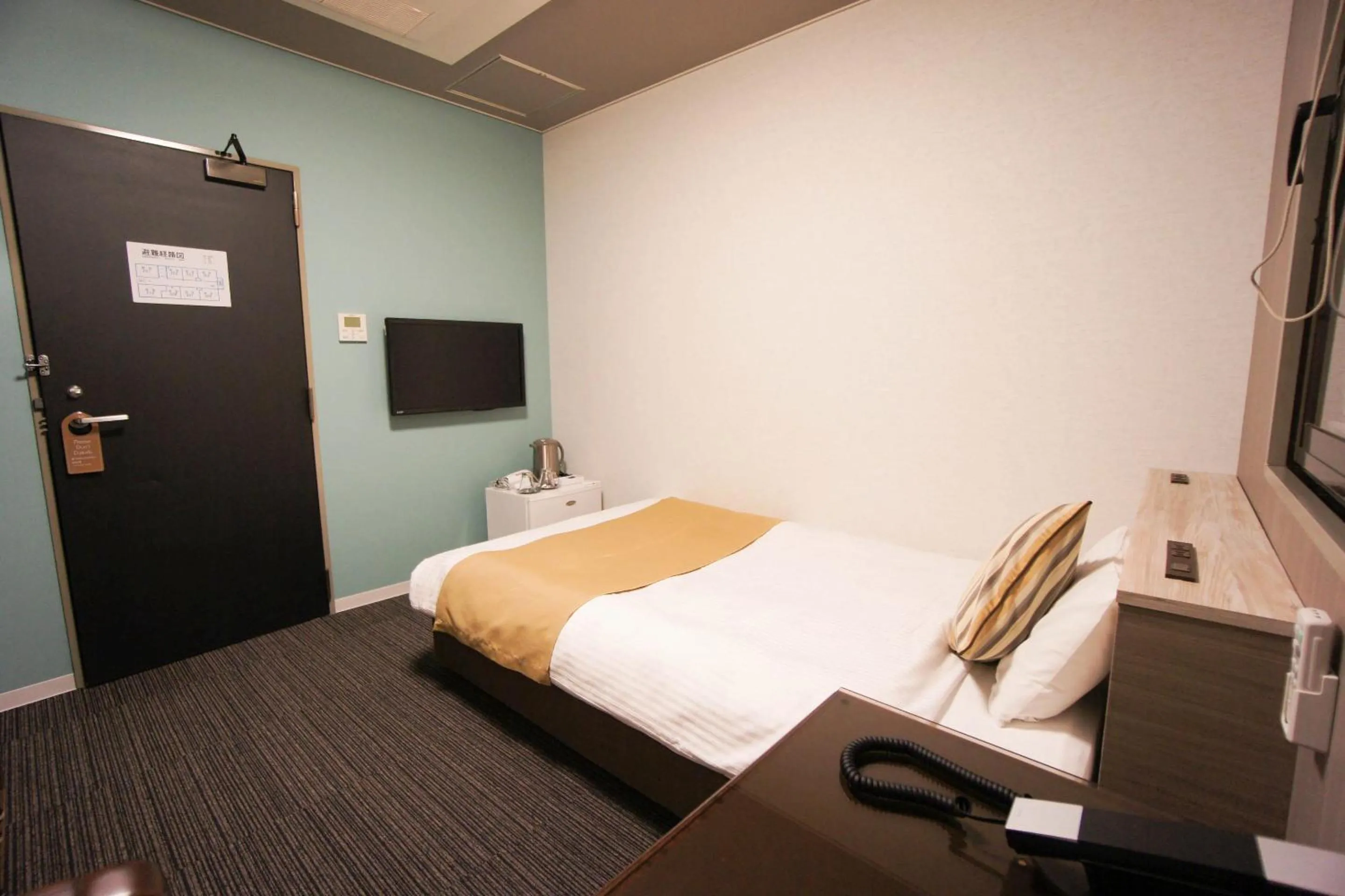 Bed in Hotel AreaOne Nobeoka