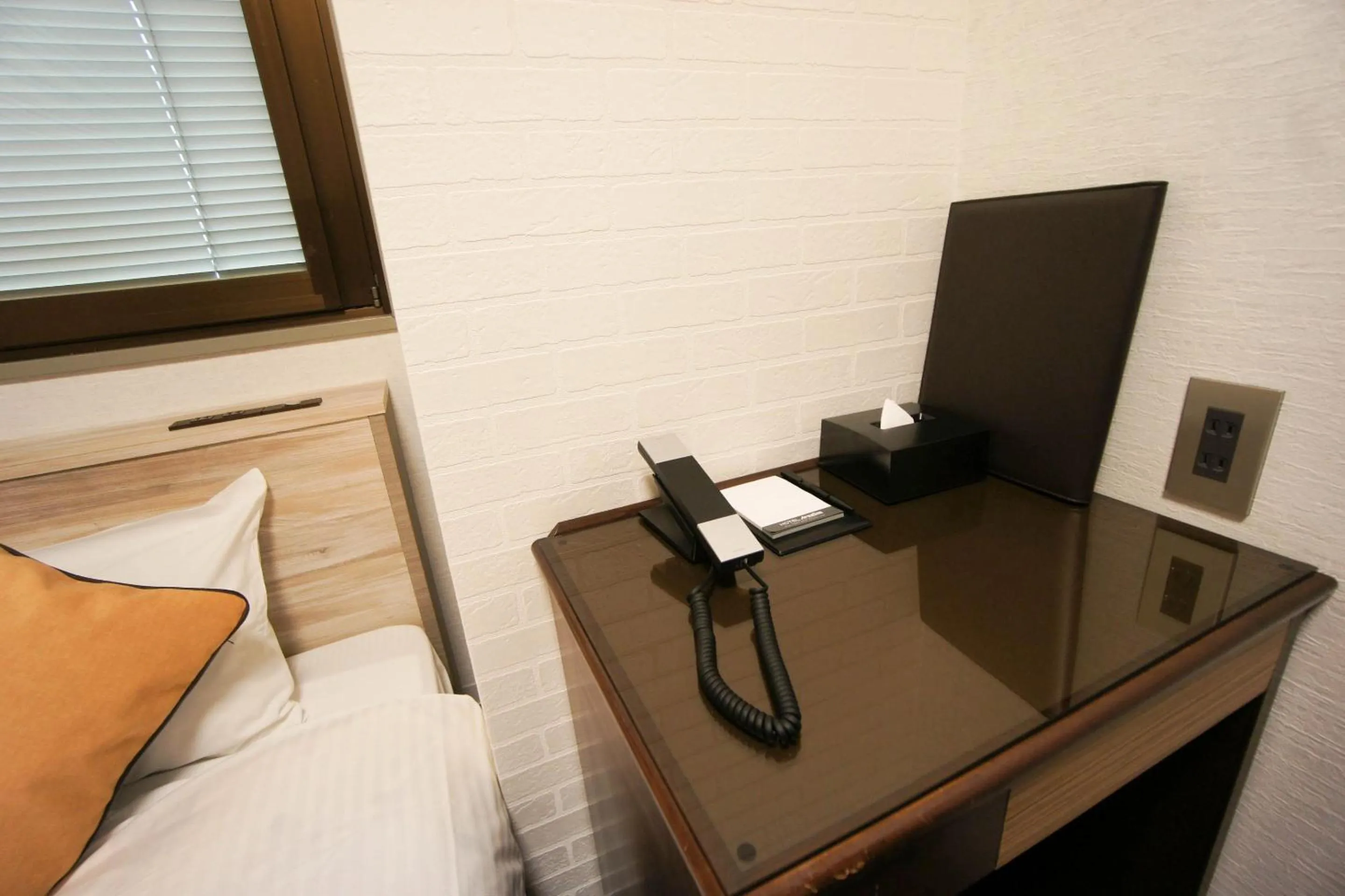 Bed in Hotel AreaOne Nobeoka