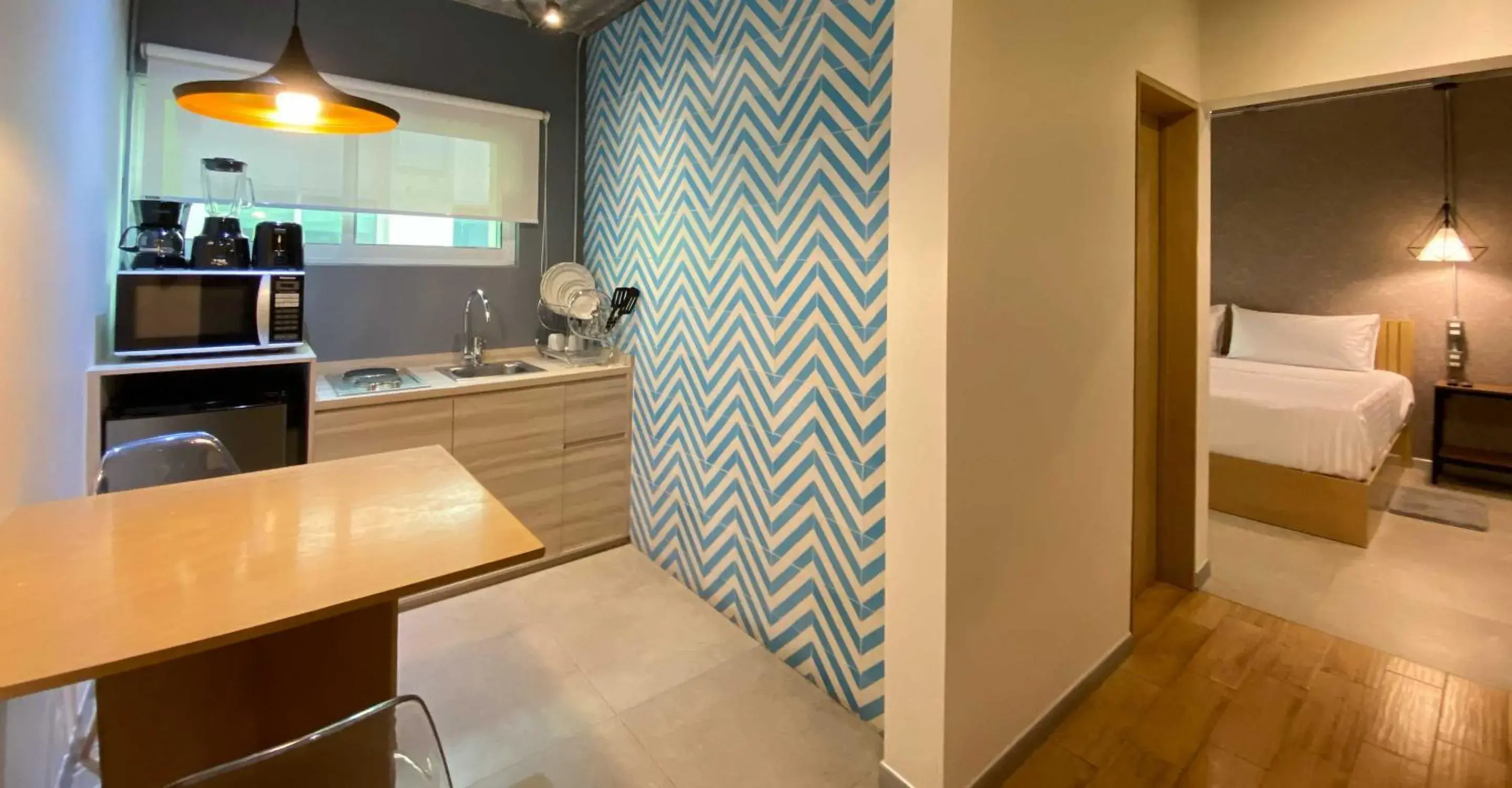 Kitchen or kitchenette, Bed in The Host Business Suites at WTC Kitchen or kitchenette, Bed in The Host Business Suites at WTC