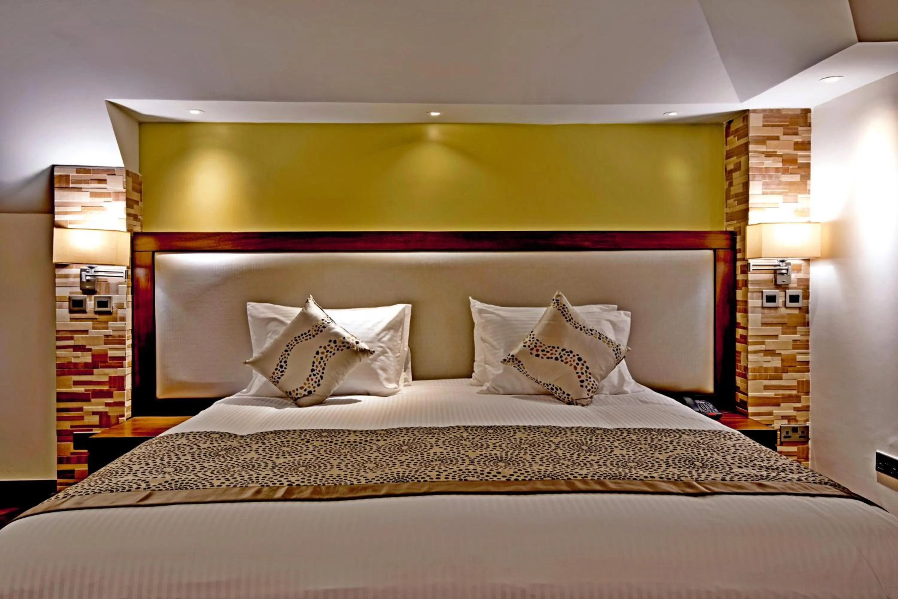 Bed in Magna Hotel and Suites