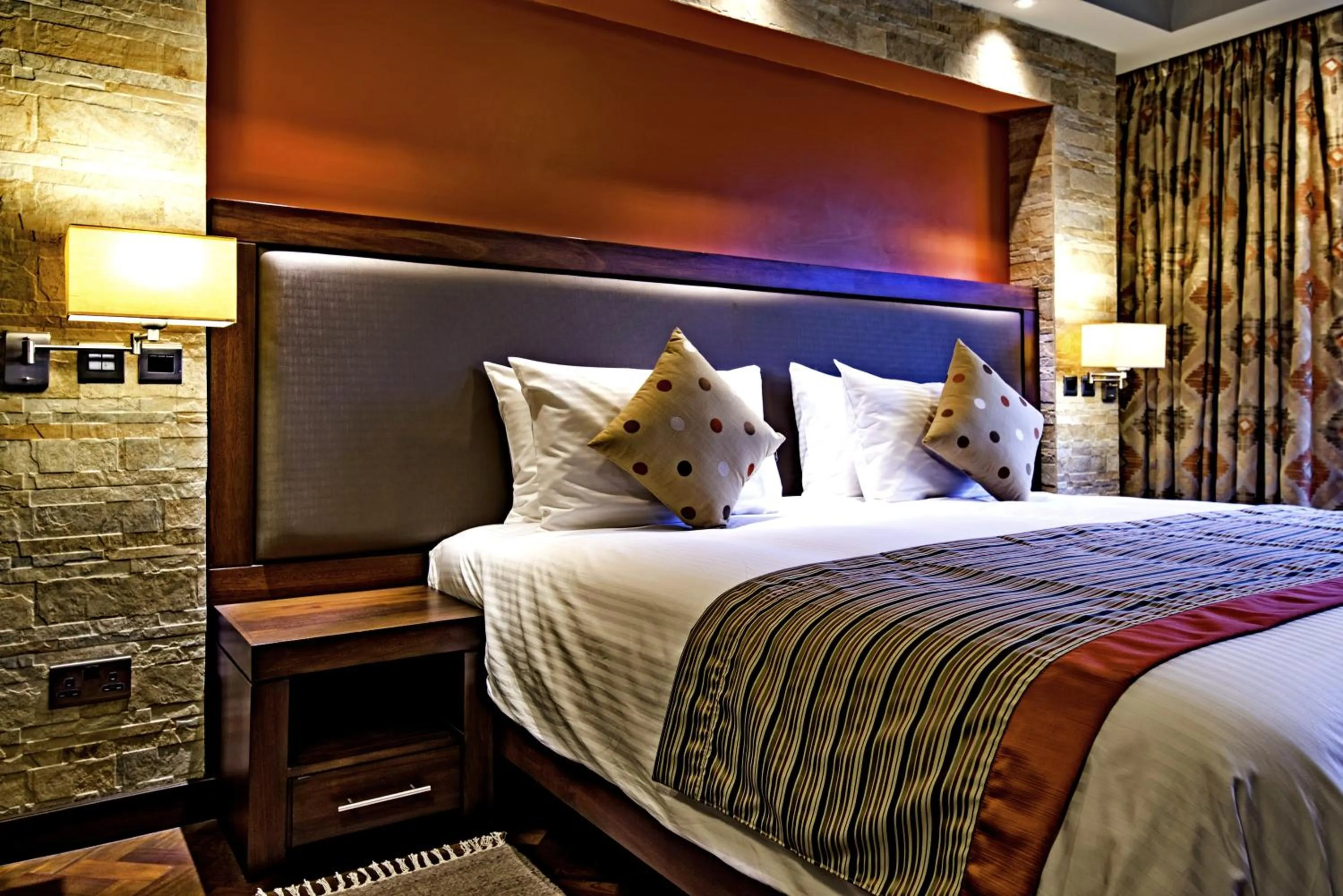 Bed in Magna Hotel and Suites