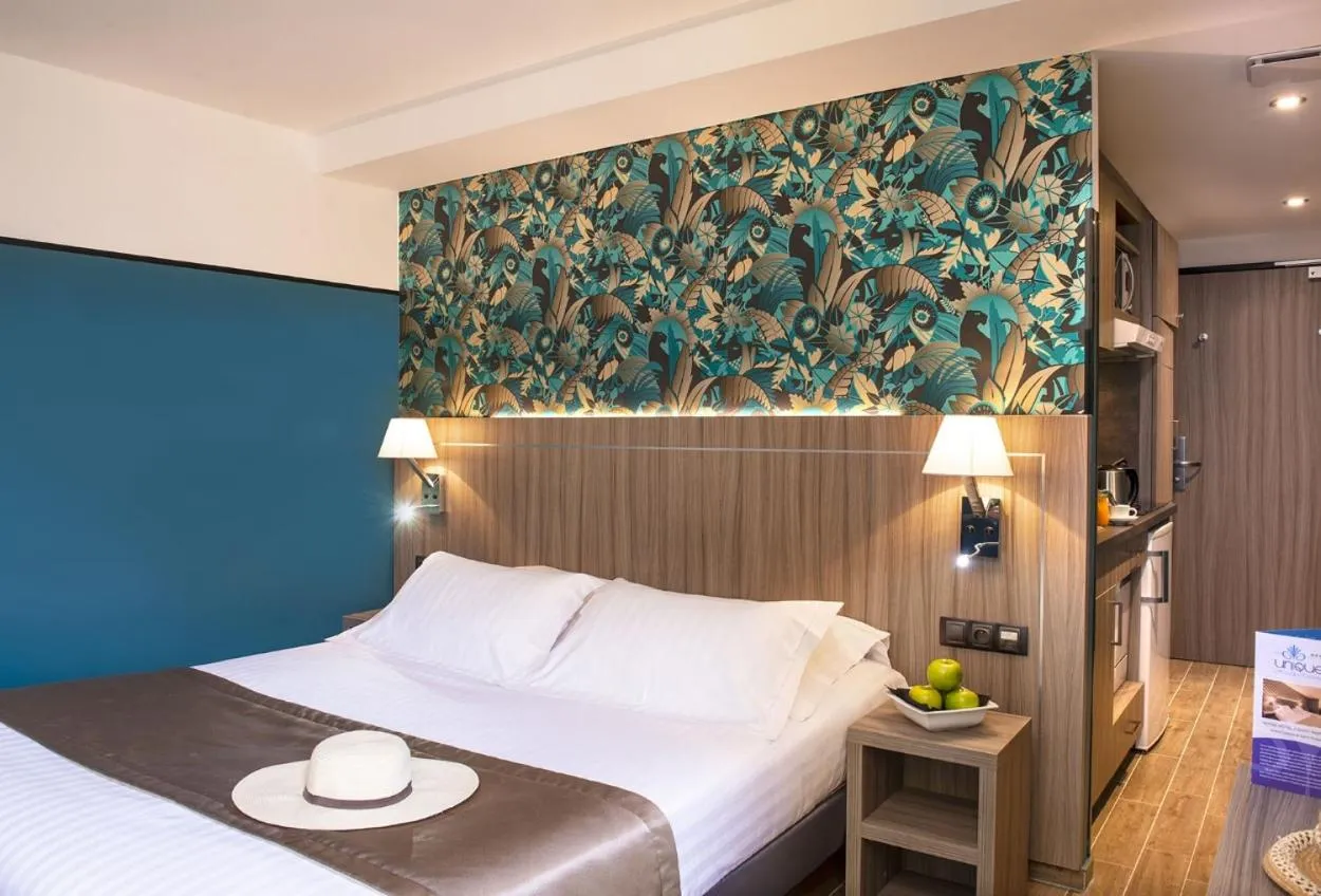 Bed in Unique Hôtel Résidence & Spa