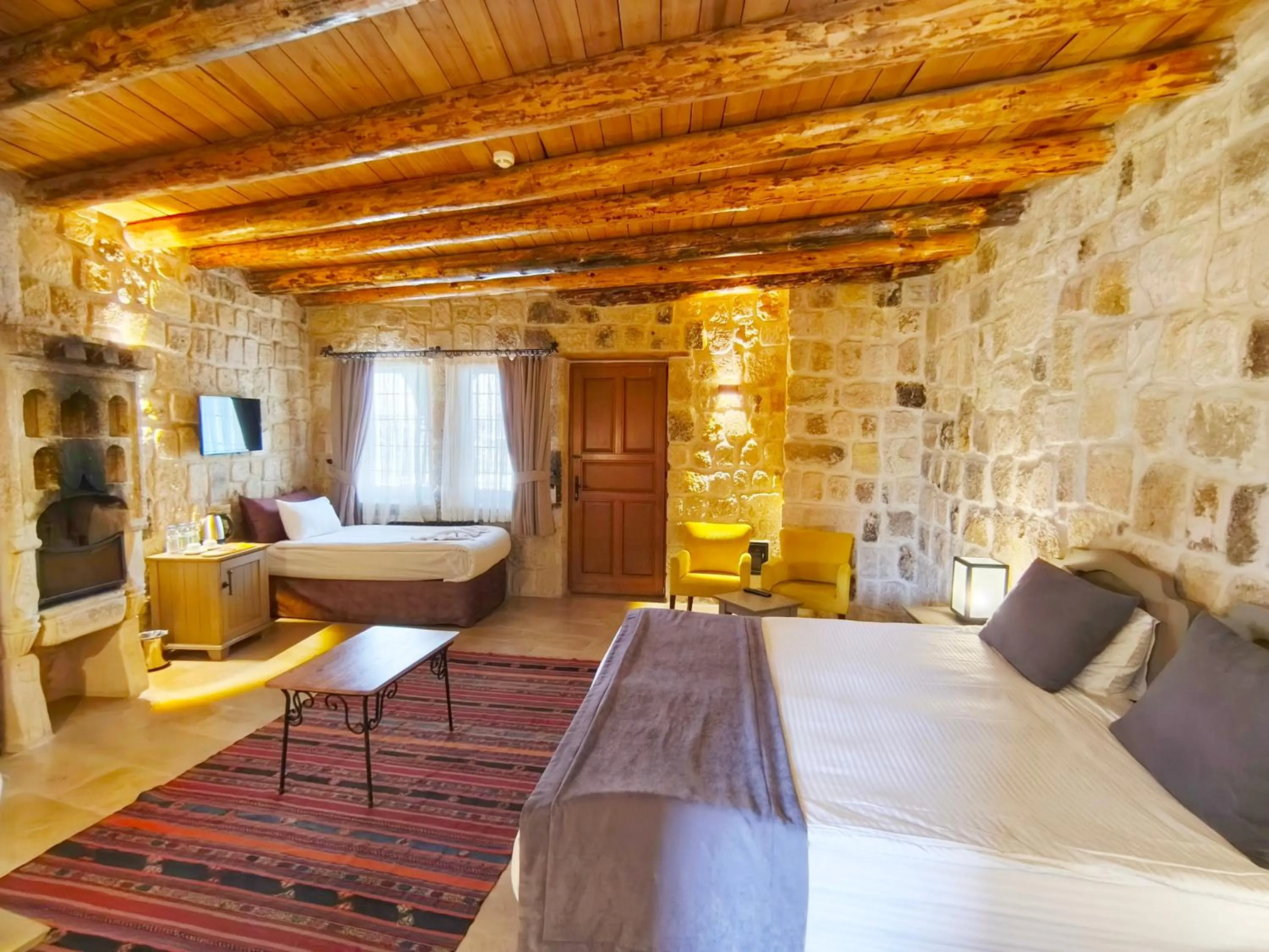 Seating area, Bed in Acropolis Cave Suite